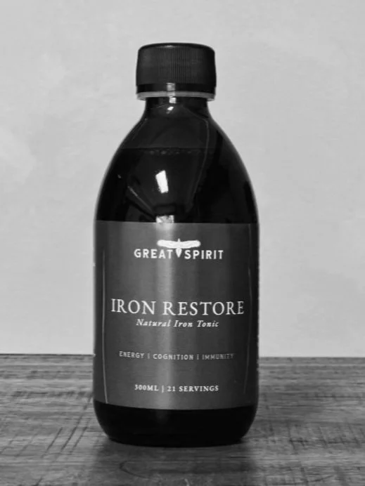 Bottle of Great Spirit Iron Restore Natural Iron Tonic on a wooden surface
