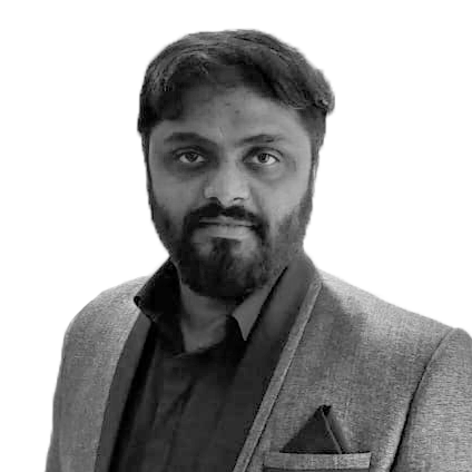 A black and white portrait of a man with a beard and mustache wearing a suit jacket and shirt.
