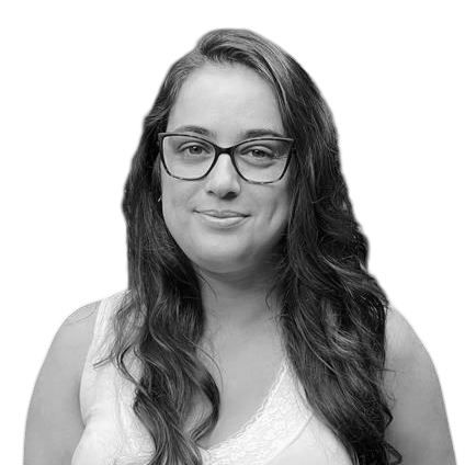 Black and white portrait of a woman with long wavy hair, wearing glasses and a sleeveless top.