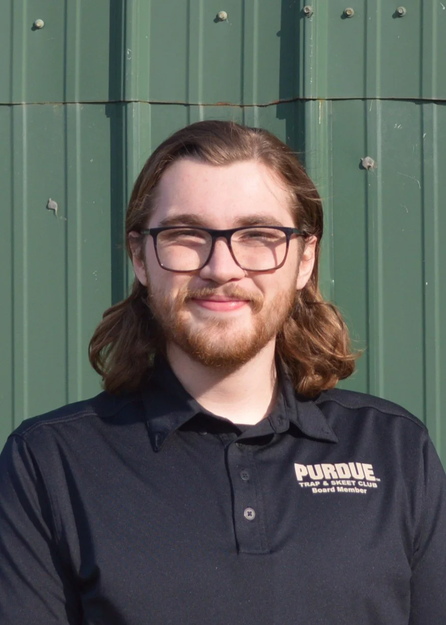 Person with glasses wearing a Purdue hoodie outdoors on a snowy day.