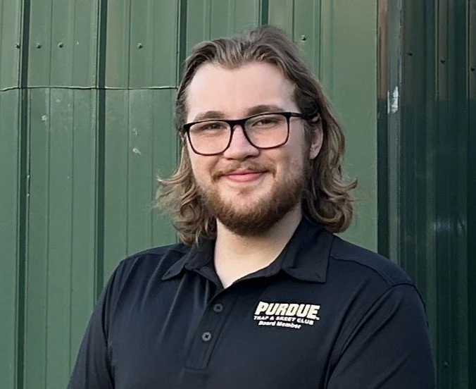 Person with glasses wearing a Purdue hoodie outdoors on a snowy day.