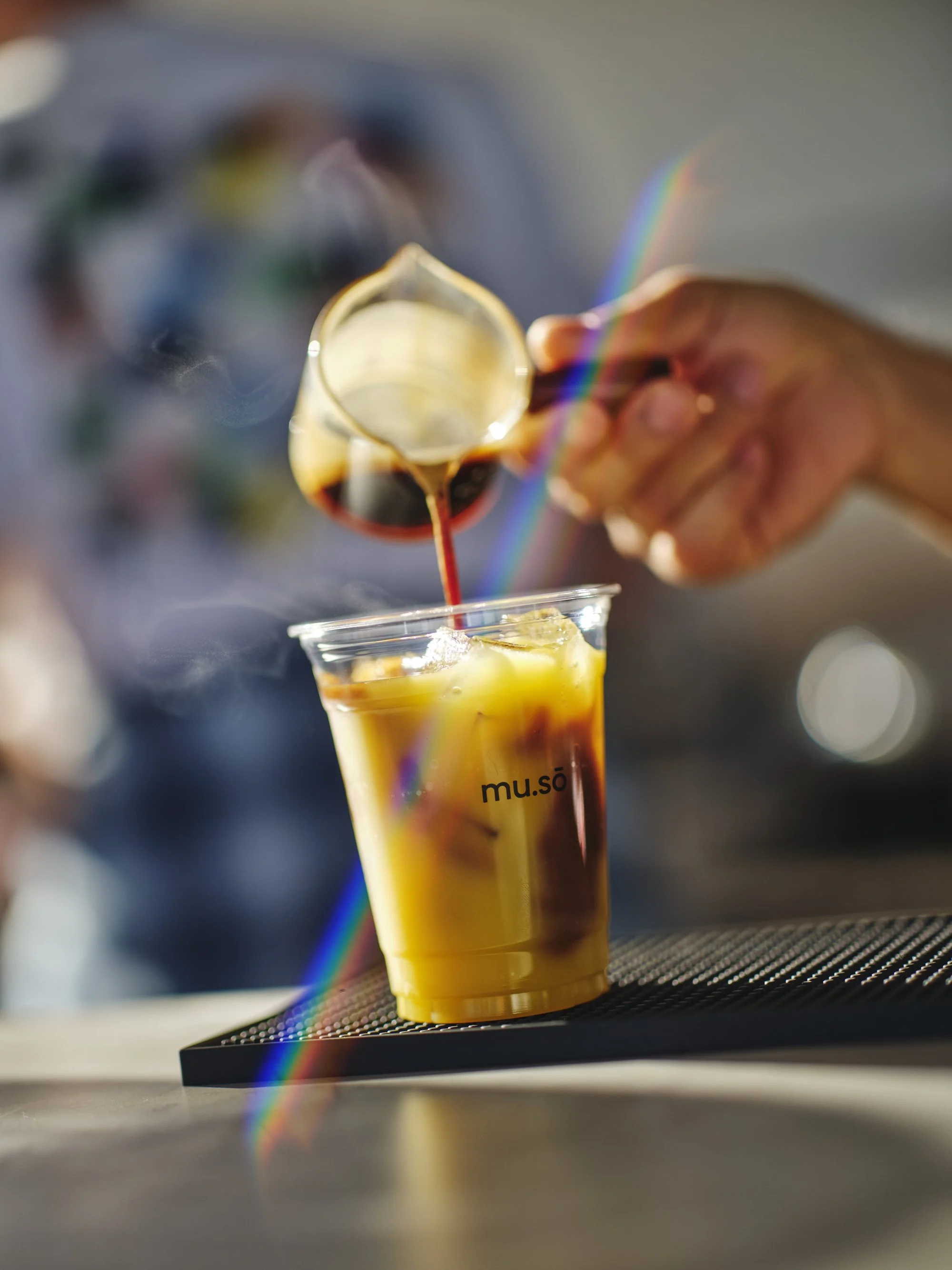 layered orange bumble espresso drink showing citrus juice and espresso separation