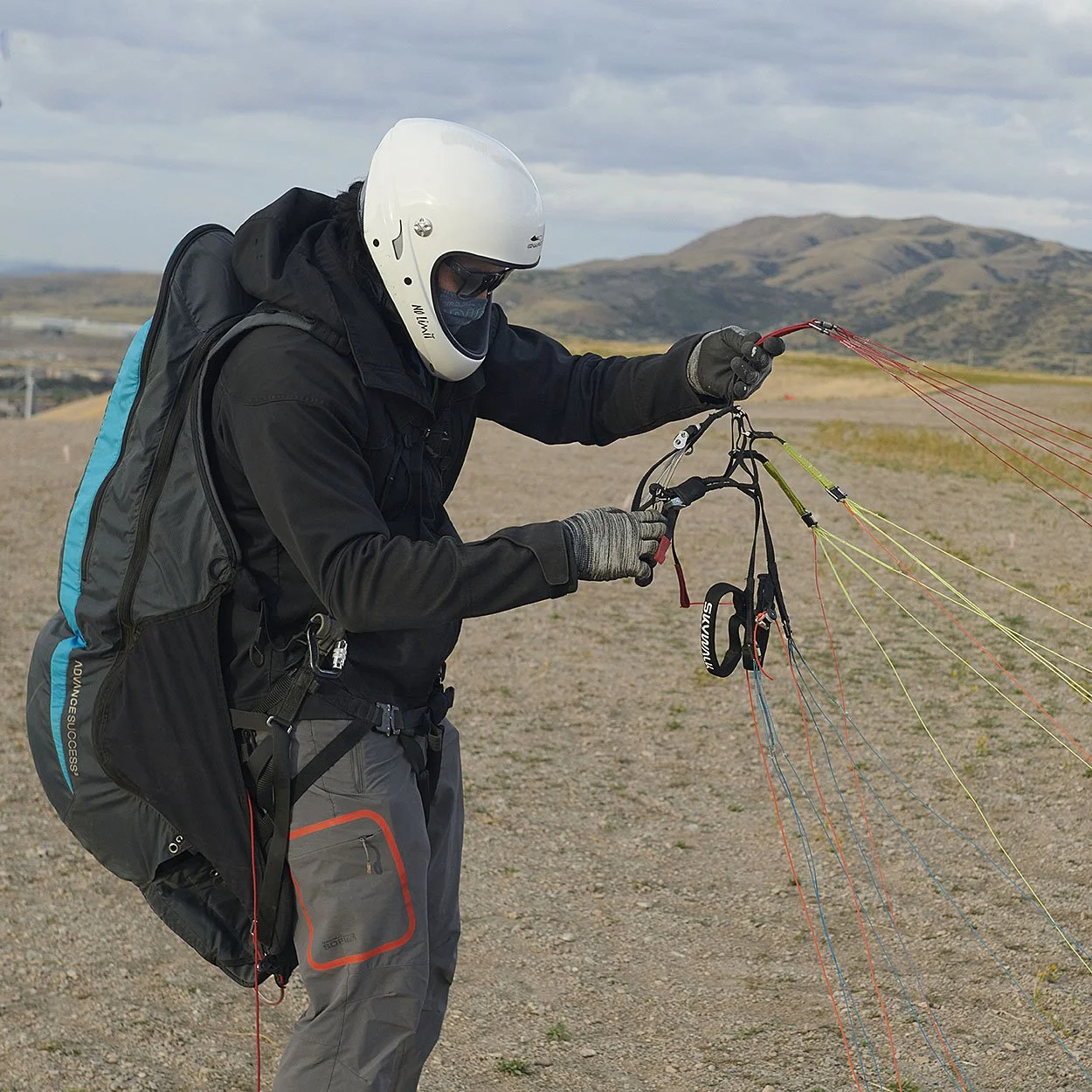 paraglider pilot performs preflight check 03.jpg
