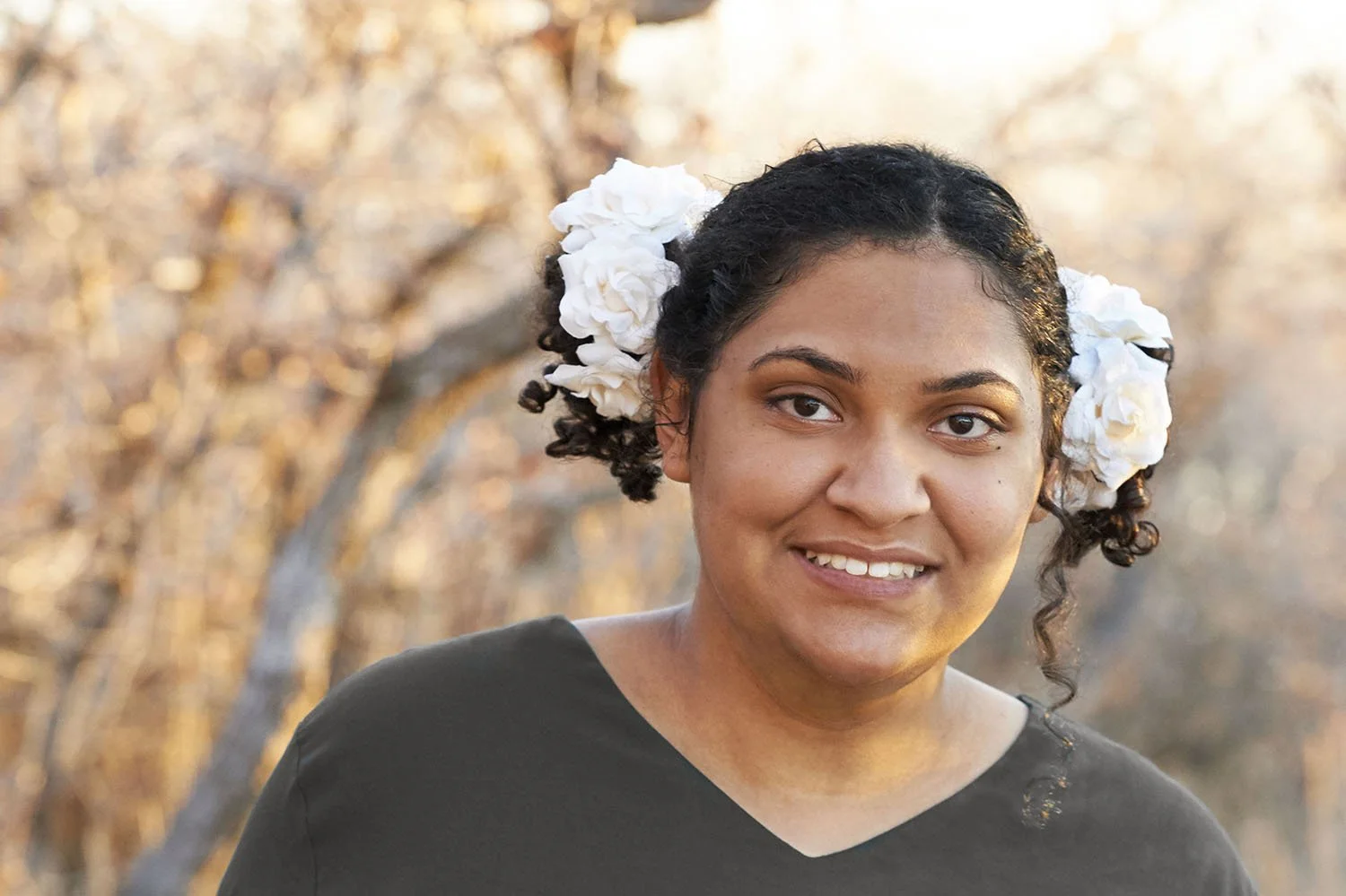senior portrait with roses in teen hair in fall scene