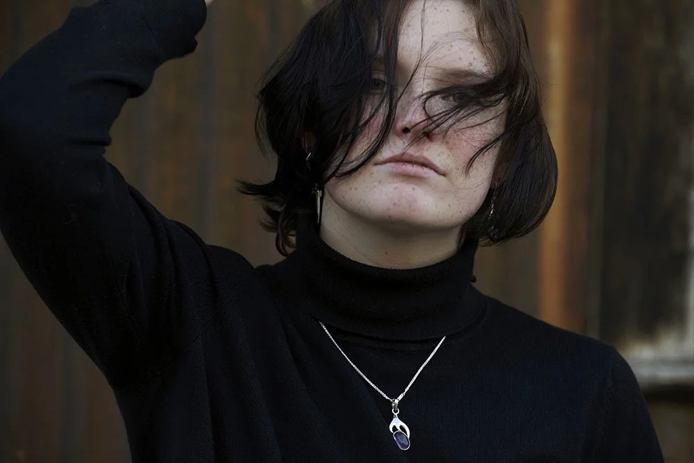 senior moody portrait of teen wearing black