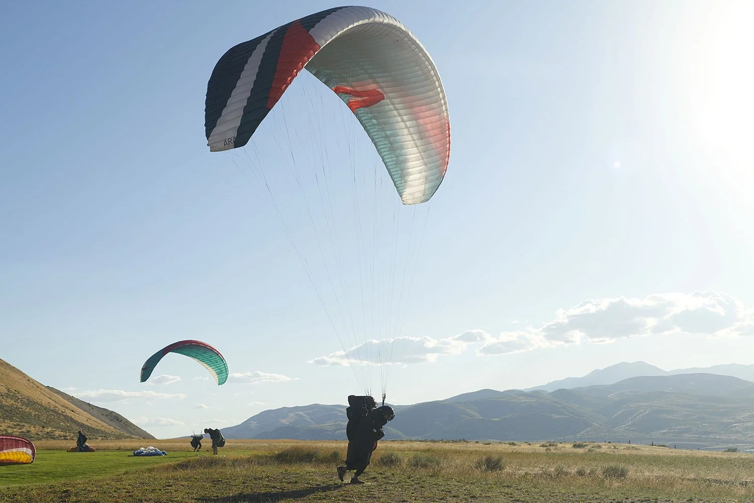 Kirsten Hepburn Photography portrait of paraglider pilot on field preparing for flight