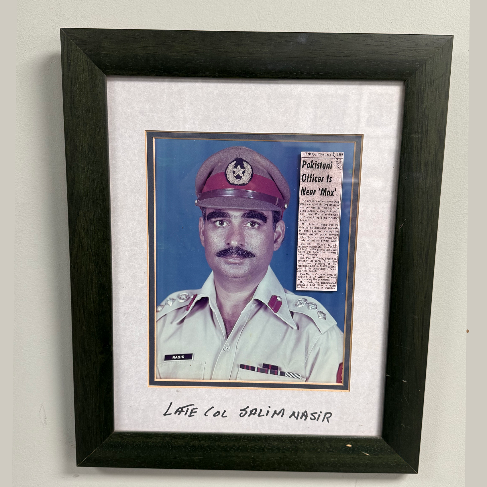 Framed photo of a uniformed military officer with a newspaper clipping