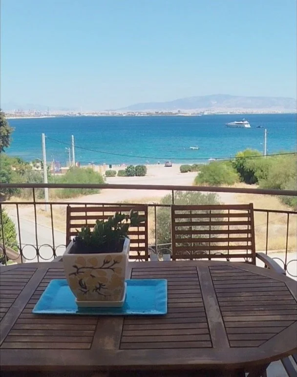 Stunning panoramic Aegean sea view from the balcony of a luxury apartment in Salamina, Greece.