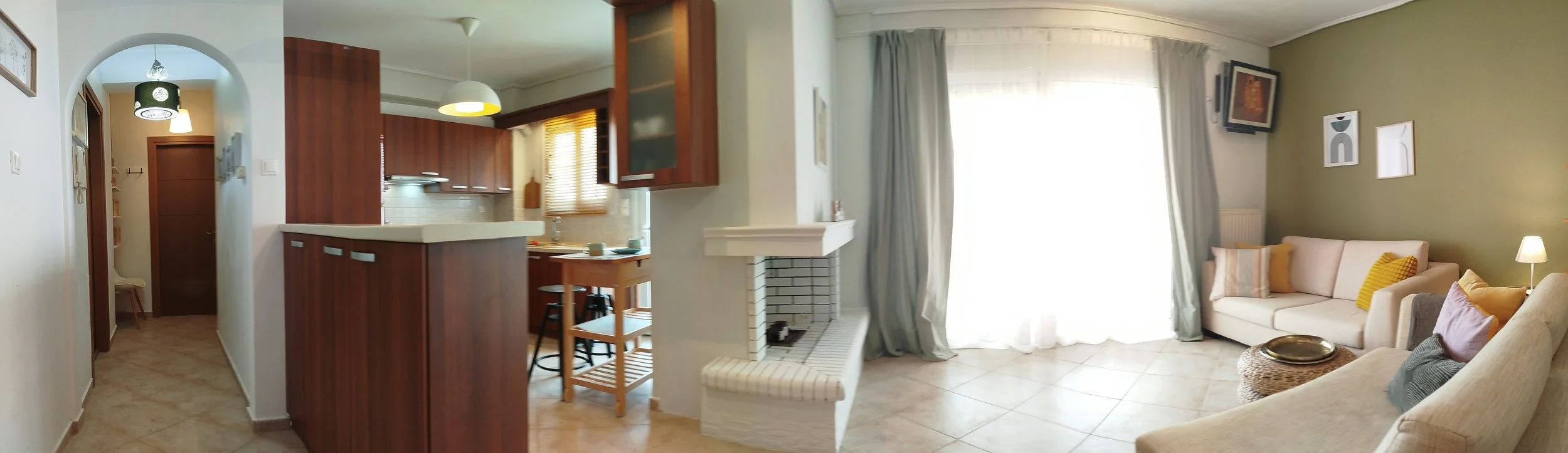 Elegant fully furnished living room with modern decor and sea view windows in Salamina apartment.