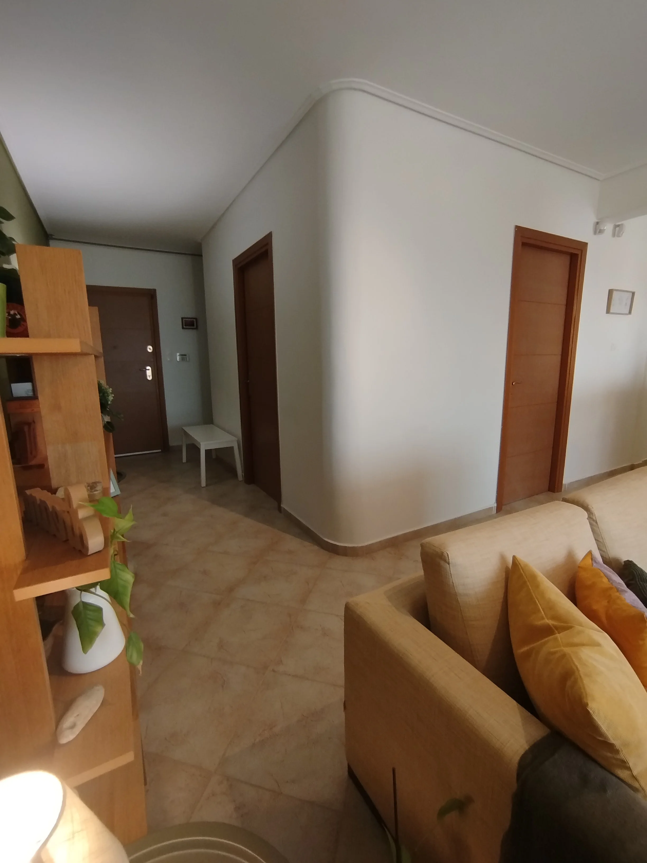 Elegant fully furnished living room with modern decor and sea view windows in Salamina apartment.