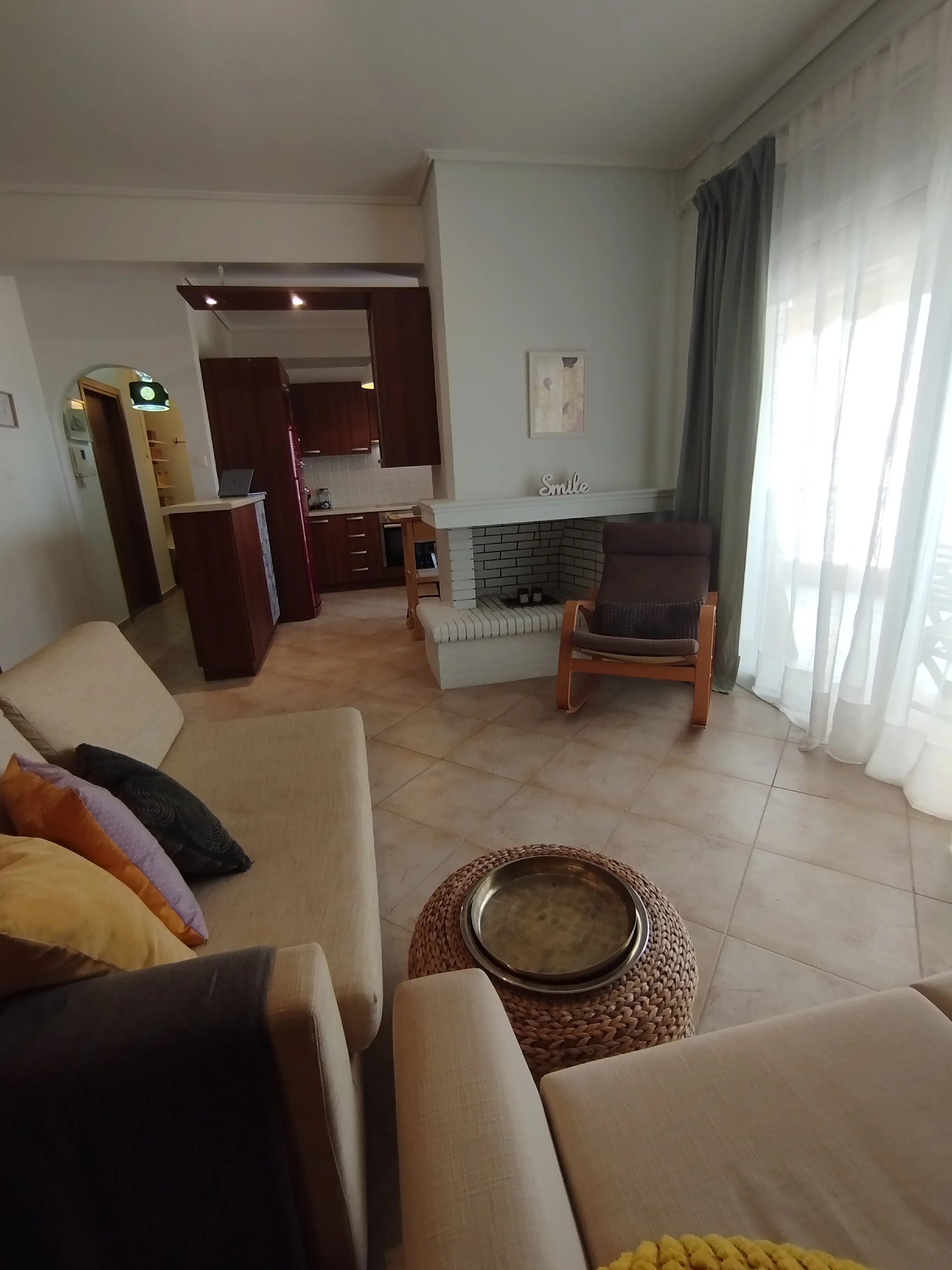 Elegant fully furnished living room with modern decor and sea view windows in Salamina apartment.
