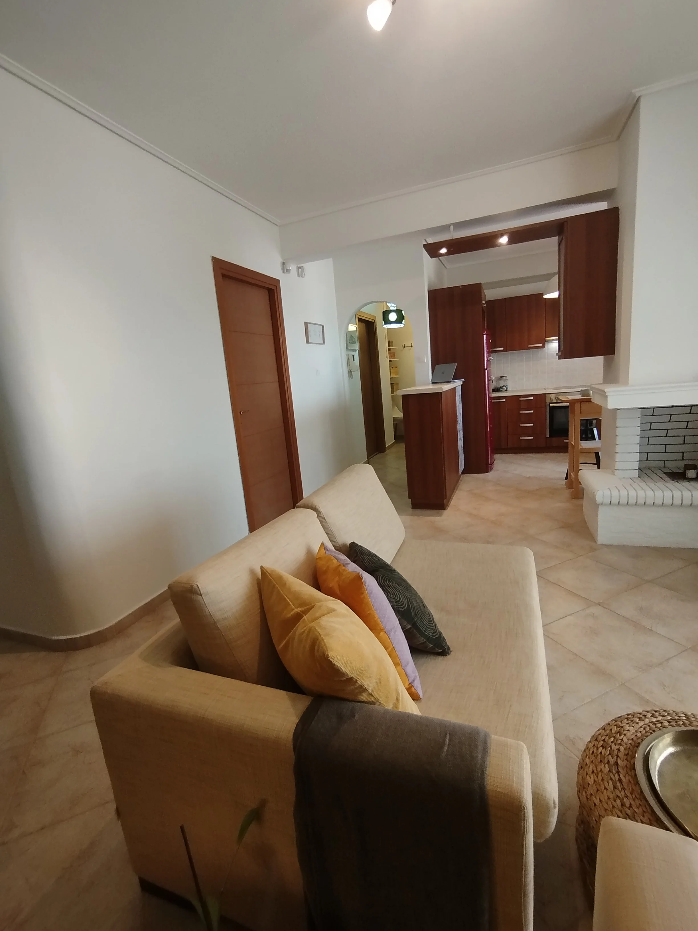 Elegant fully furnished living room with modern decor and sea view windows in Salamina apartment.