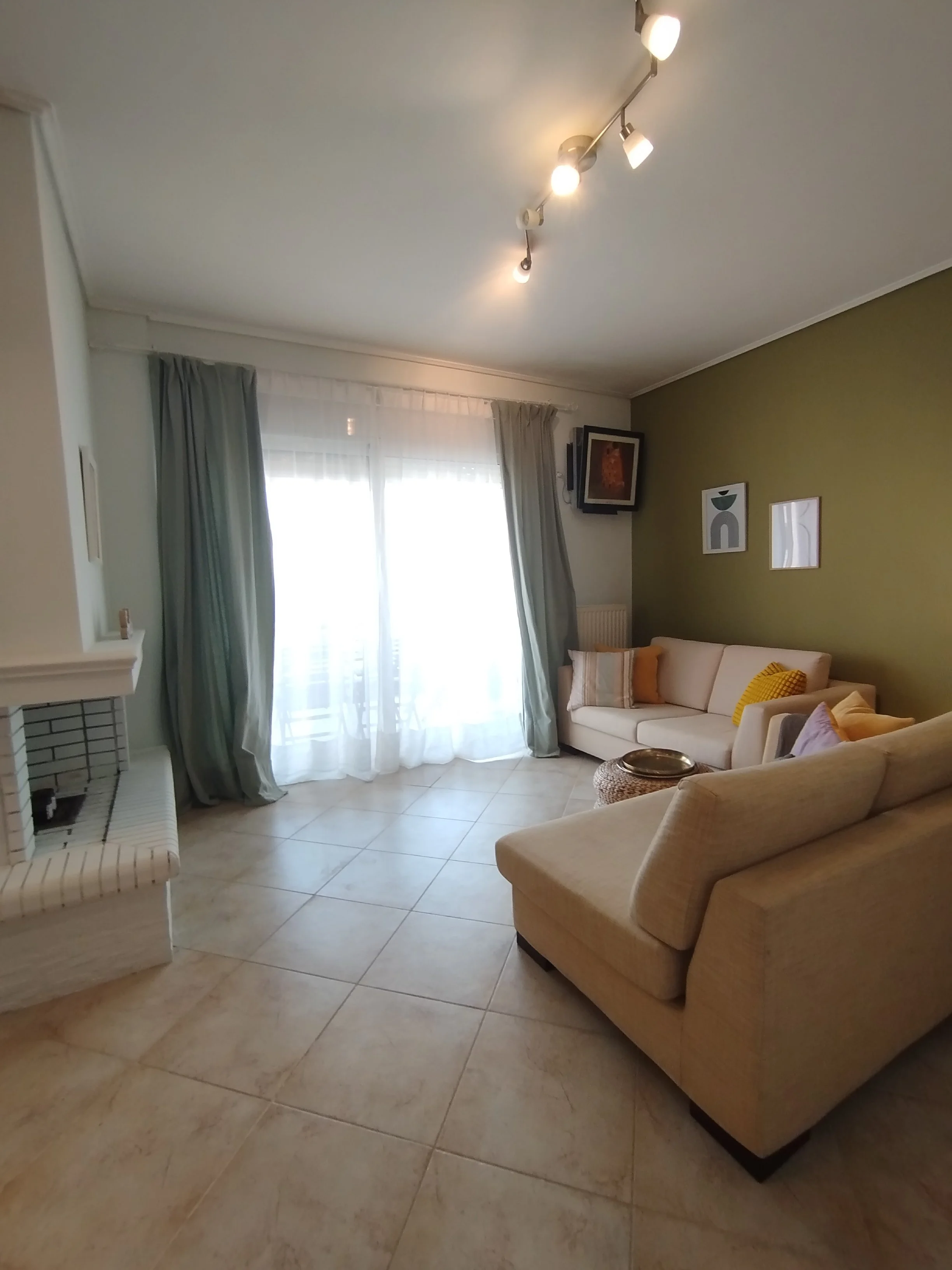 Elegant fully furnished living room with modern decor and sea view windows in Salamina apartment.