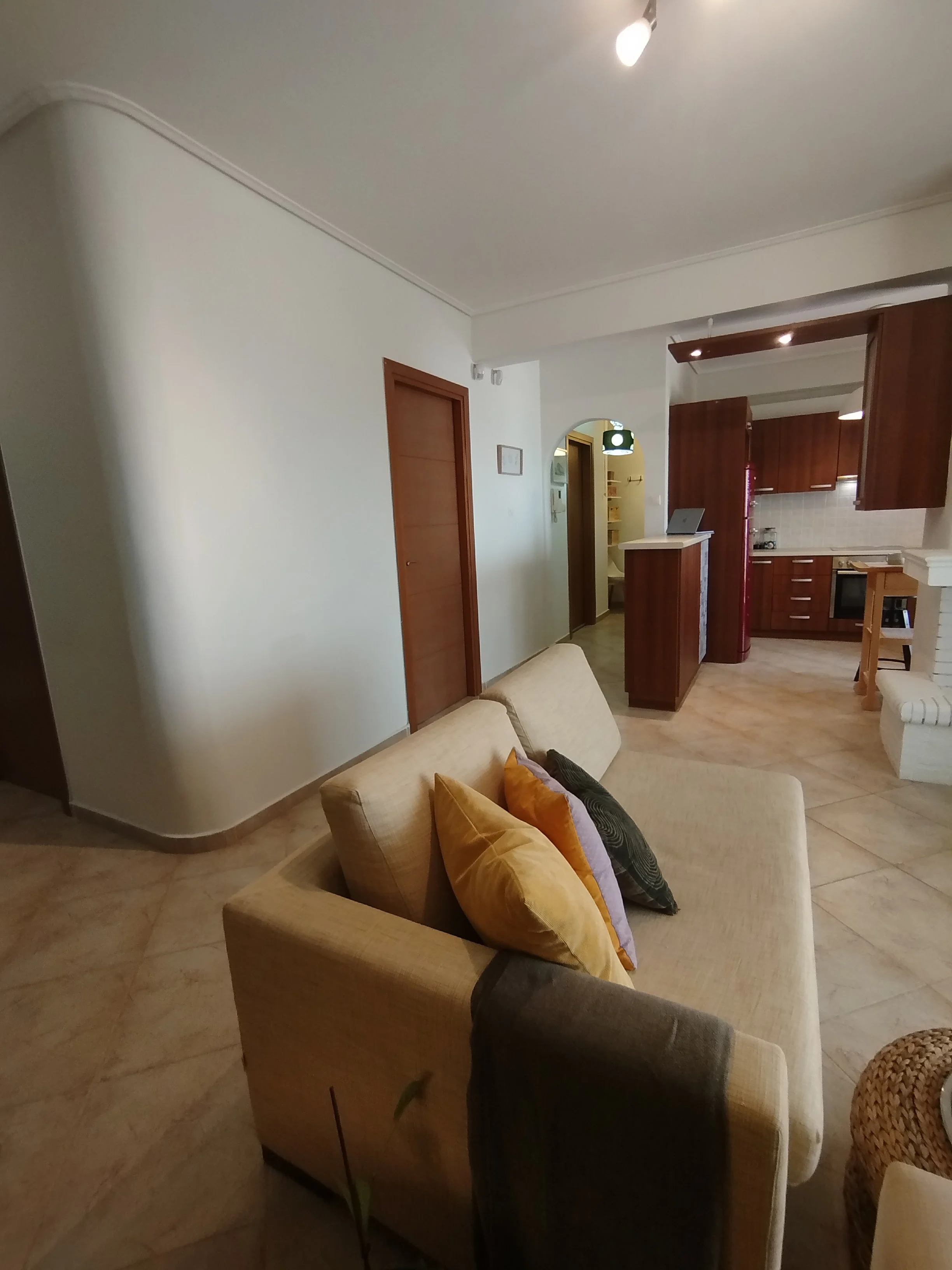 Elegant fully furnished living room with modern decor and sea view windows in Salamina apartment.