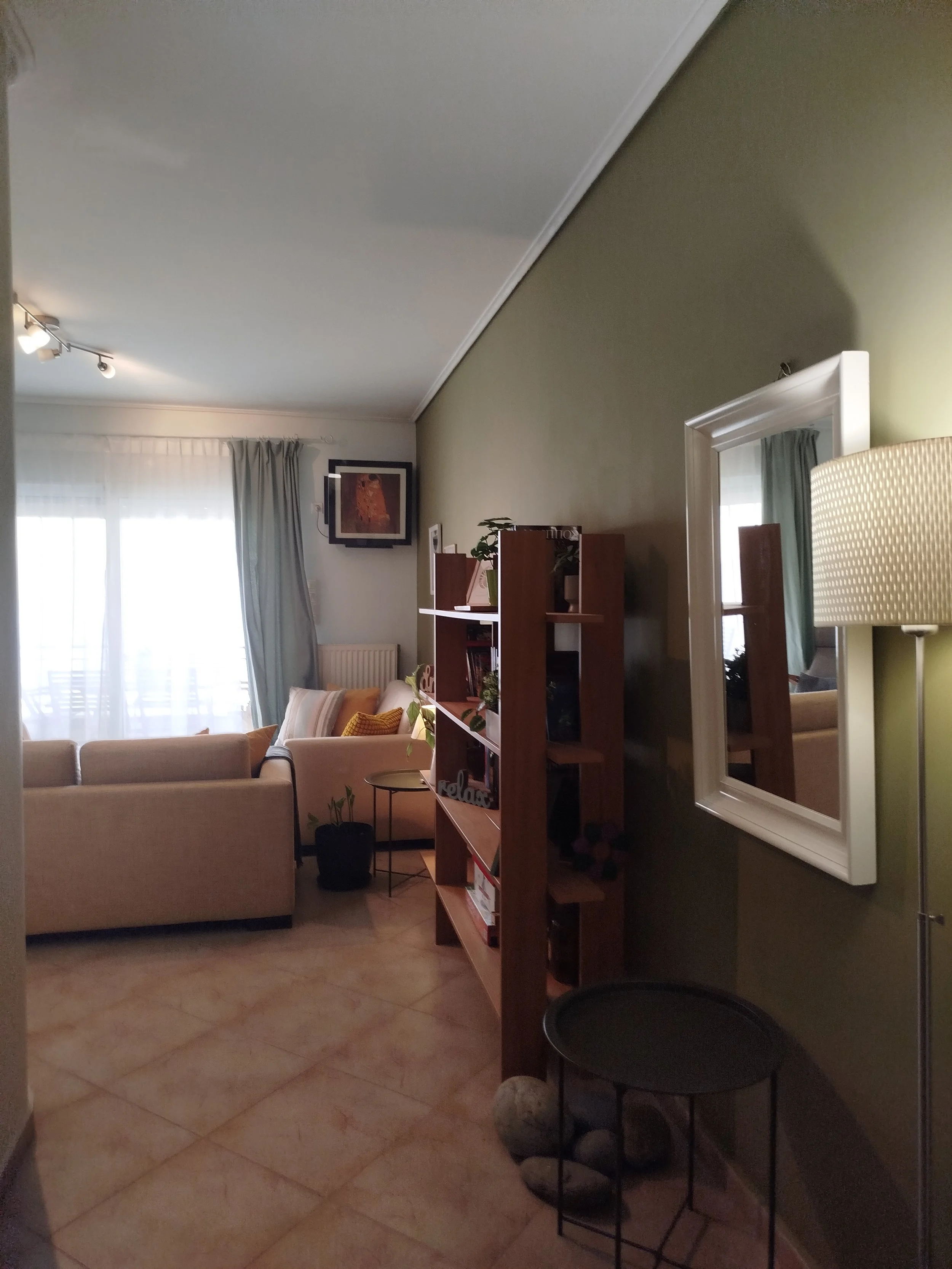 Elegant fully furnished living room with modern decor and sea view windows in Salamina apartment.