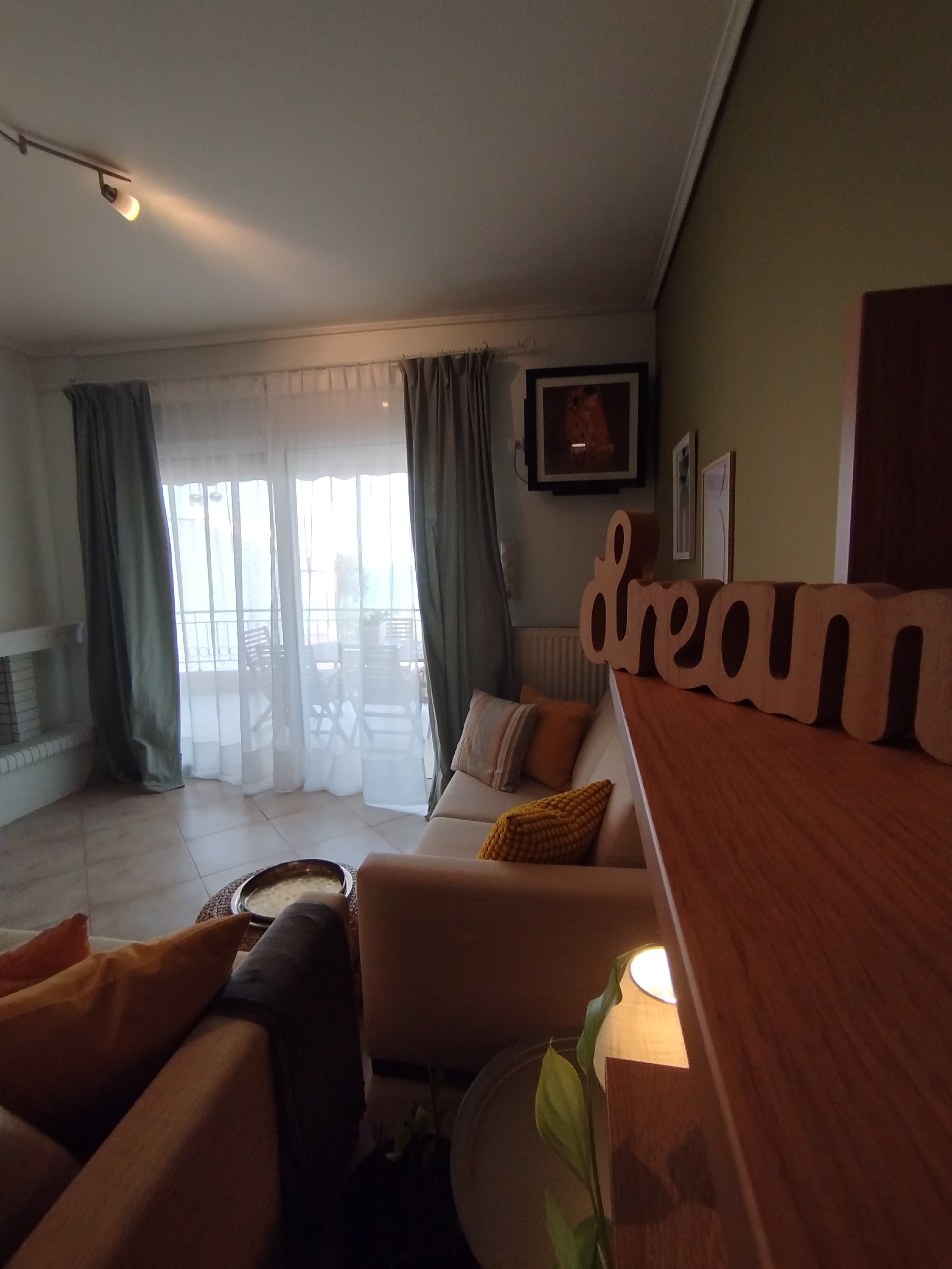 Elegant fully furnished living room with modern decor and sea view windows in Salamina apartment.