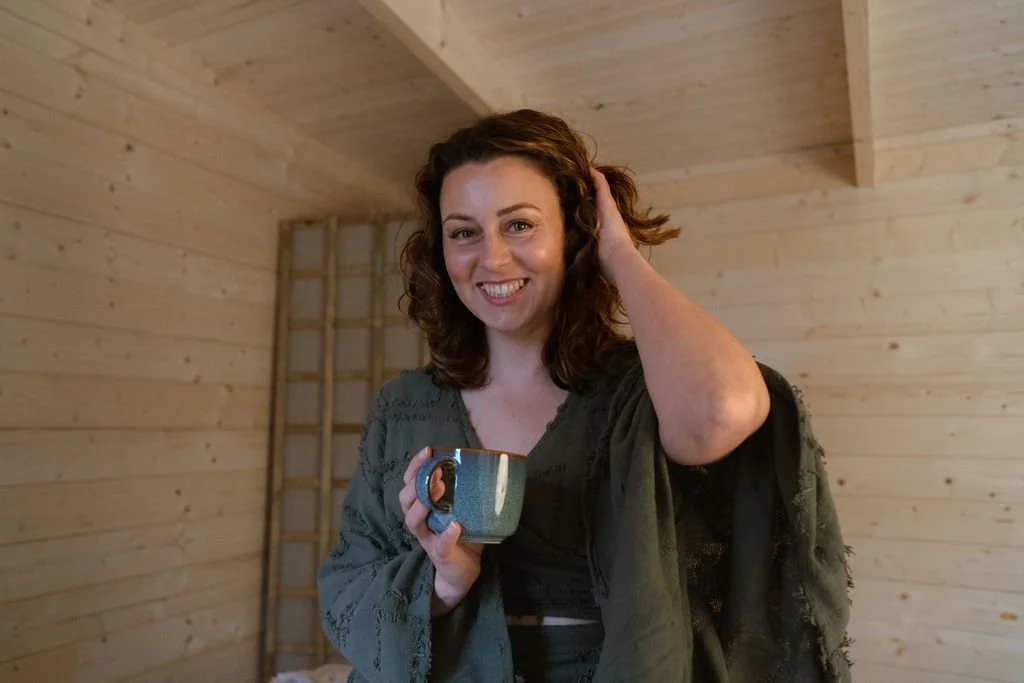 Image of Charlotte, founder of Life Sparc, smiling in the cabin