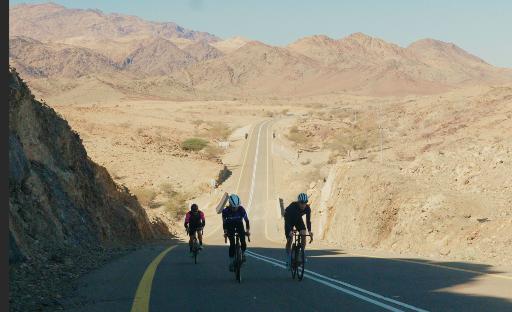 Cyclist going uphill on a touring trip in Saudi Arabia