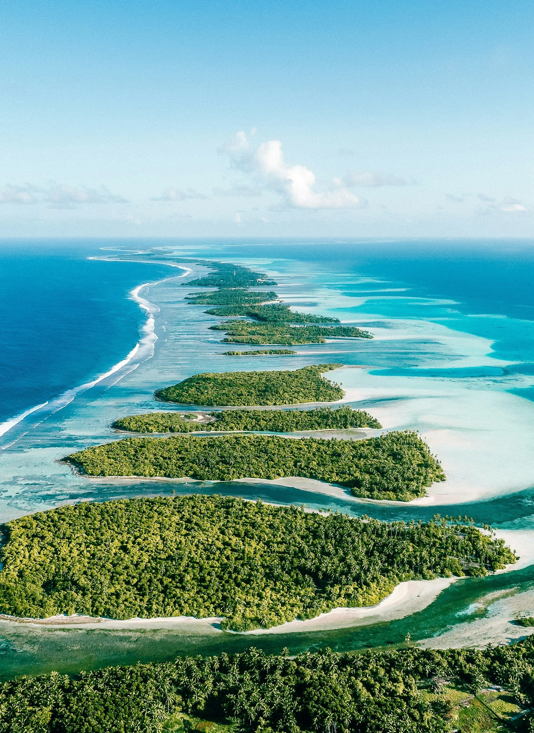 Aerial view of Maldivian atoll chain with turquoise lagoons and reefs