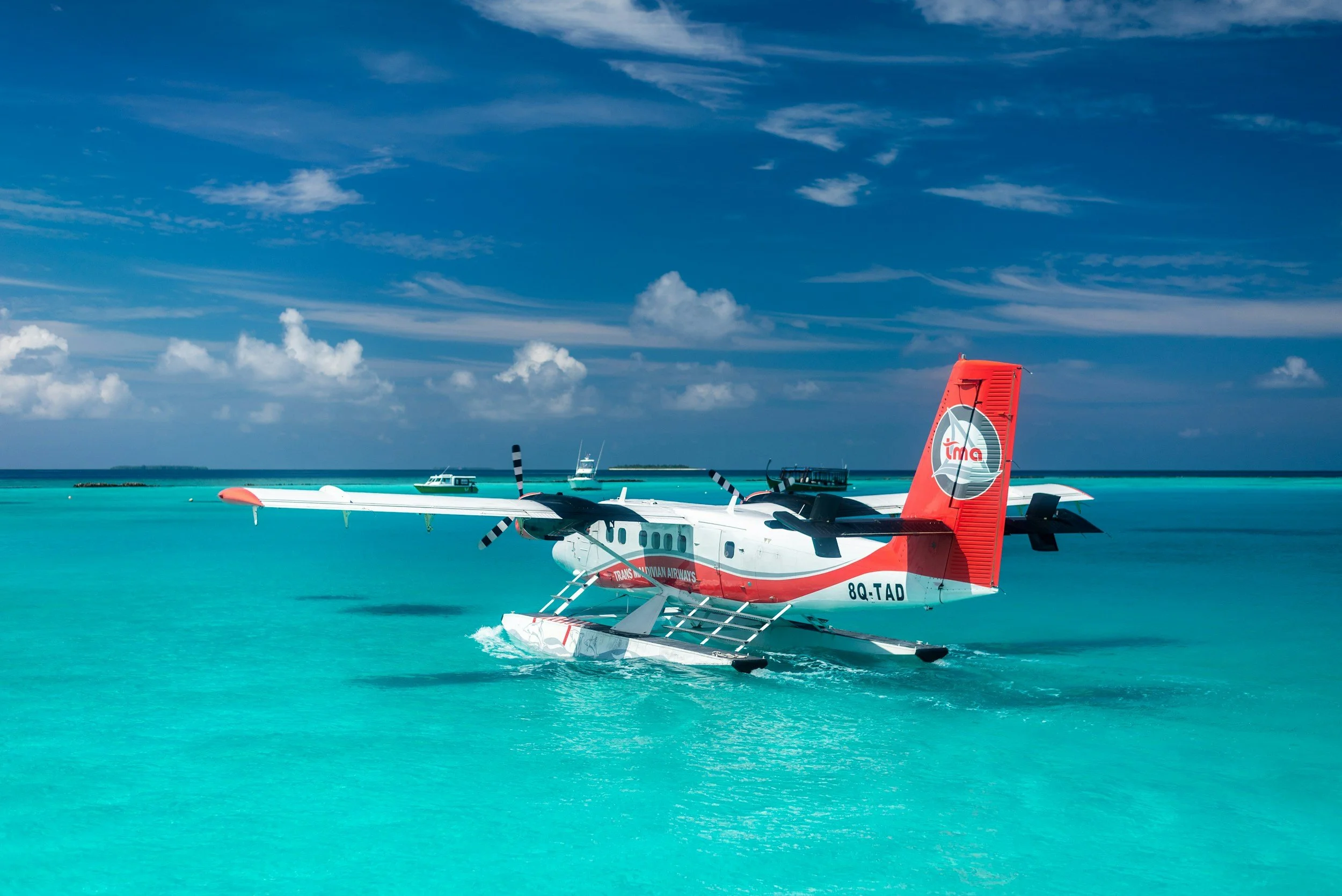 Maldivian seaplane preparing for takeoff over a bright turquoise lagoon