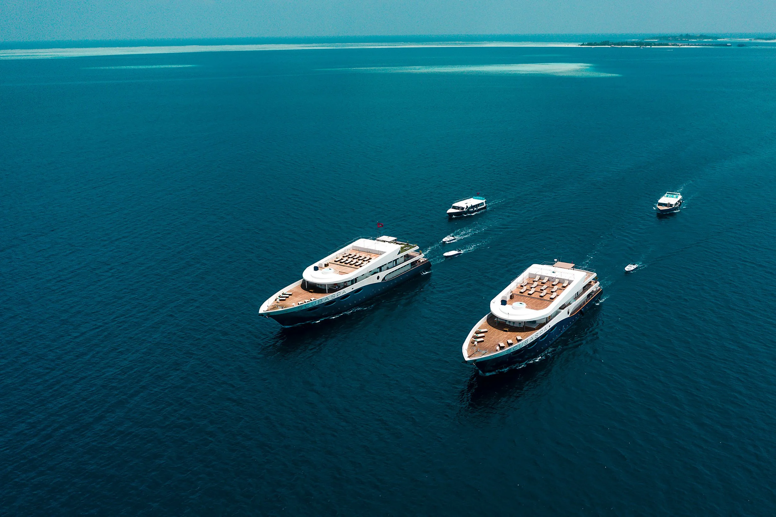 Two luxury Scubaspa liveaboard yachts sailing through the Maldives