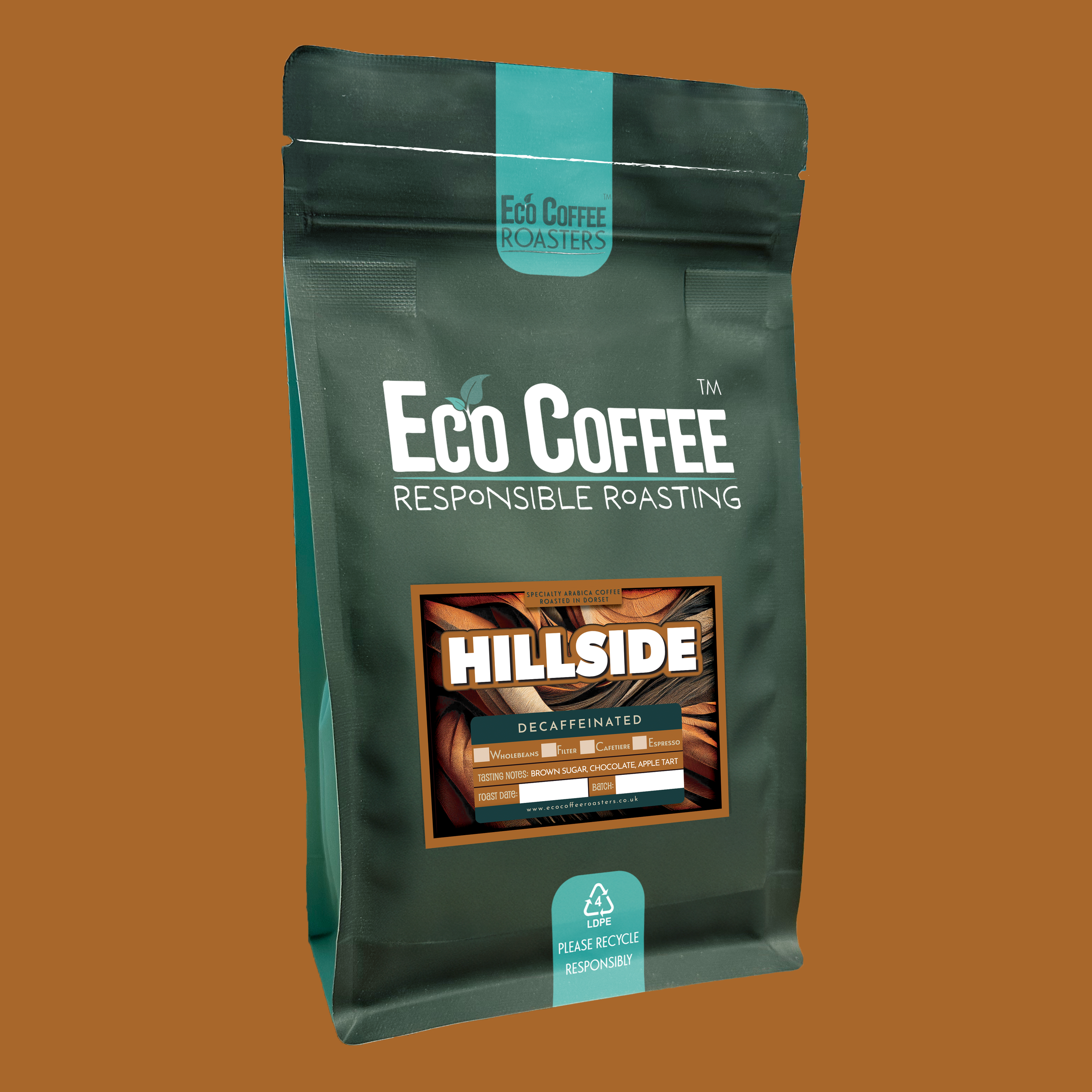 Eco Coffee Roasters Hillside Decaffeinated coffee package in a stylized landscape with golden fields and a small building on a hill.