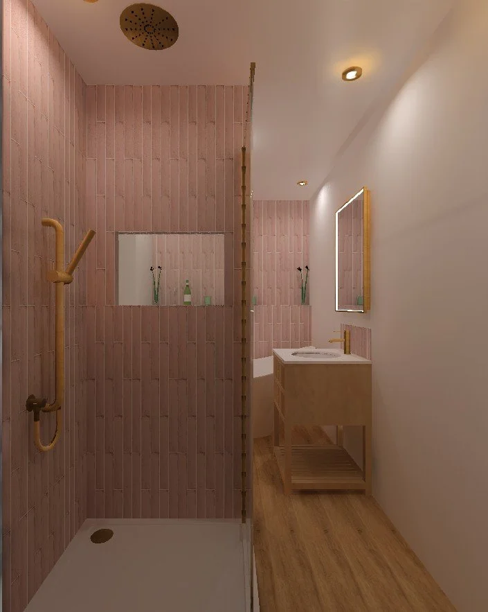 A bathroom with a walk-in shower on the left side with pink tiles, a gold grab bar, and a ceiling rain shower head. On the right side, there is a wooden vanity with a mirror, a white countertop, and a sink. The flooring is wood, and there are small g