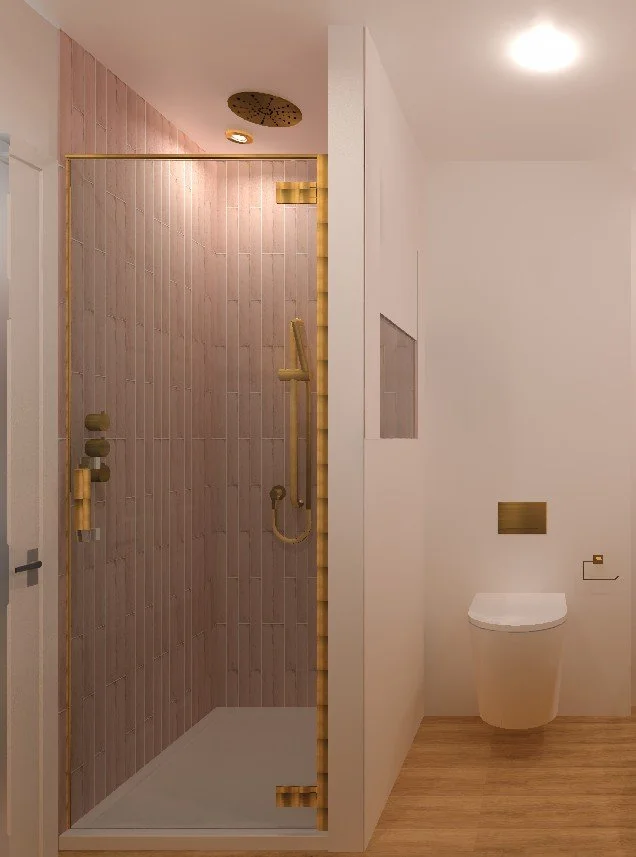 A modern bathroom with a walk-in shower featuring pinkish tiles and gold fixtures, separated by a partial wall from a white toilet on a wood floor, with a ceiling light and visible shower head.