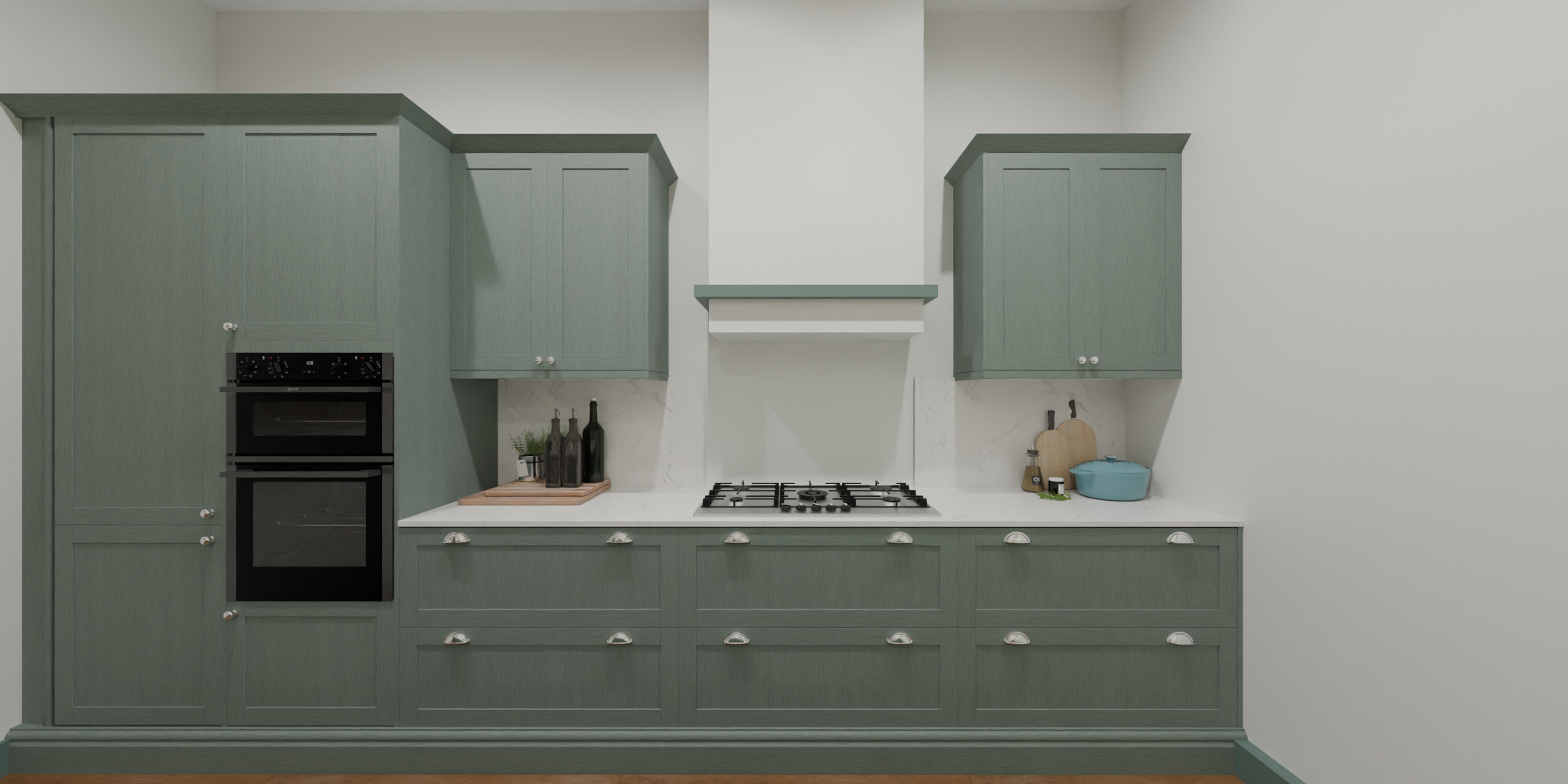 Green kitchen cabinets with black double oven, white countertop, gas stove, and decorative items like bottles, cutting boards, and a blue pot.