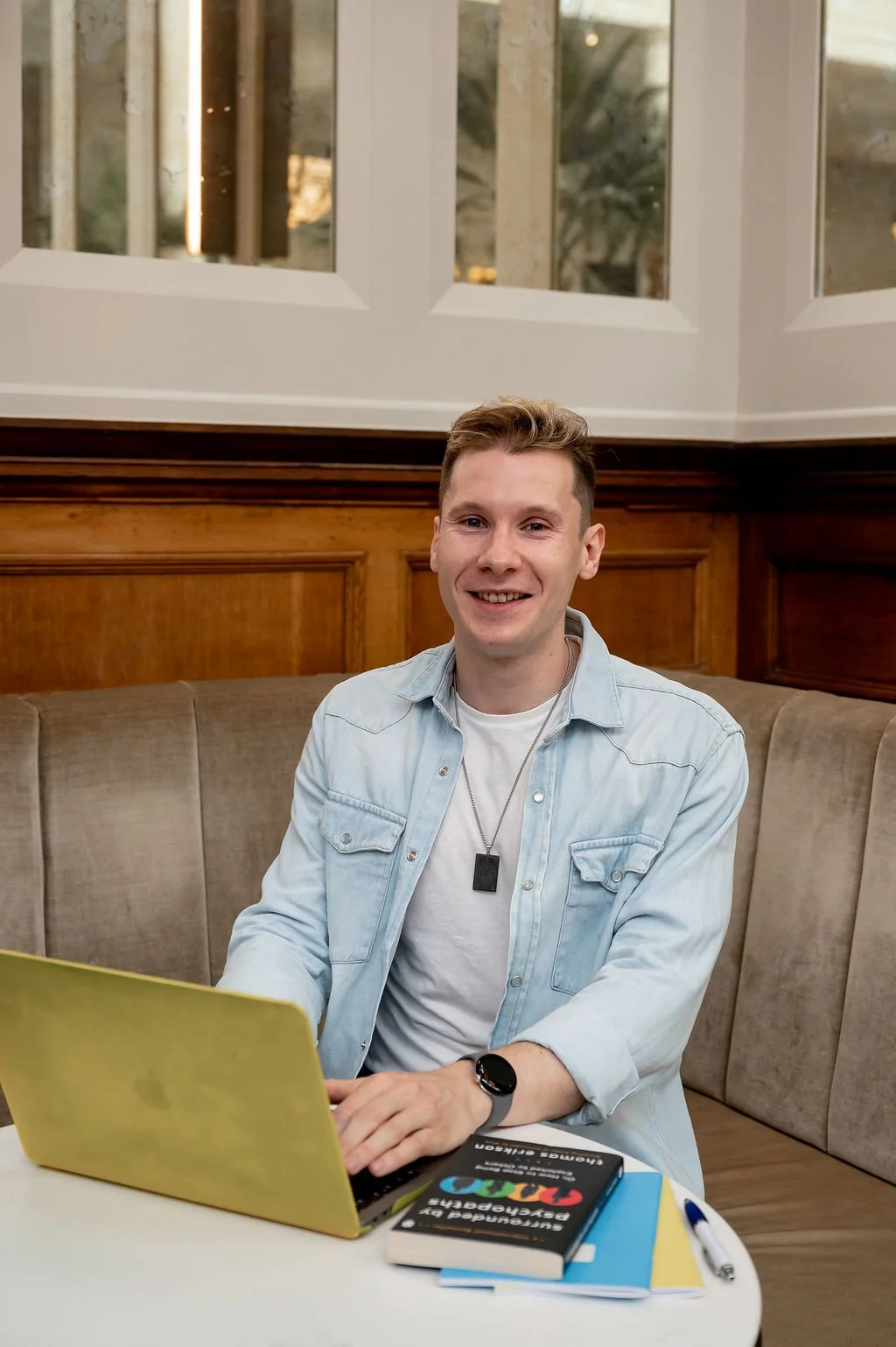 Liam Marshall, freelance content writer and copywriter, working on a laptop in a warm interior setting.