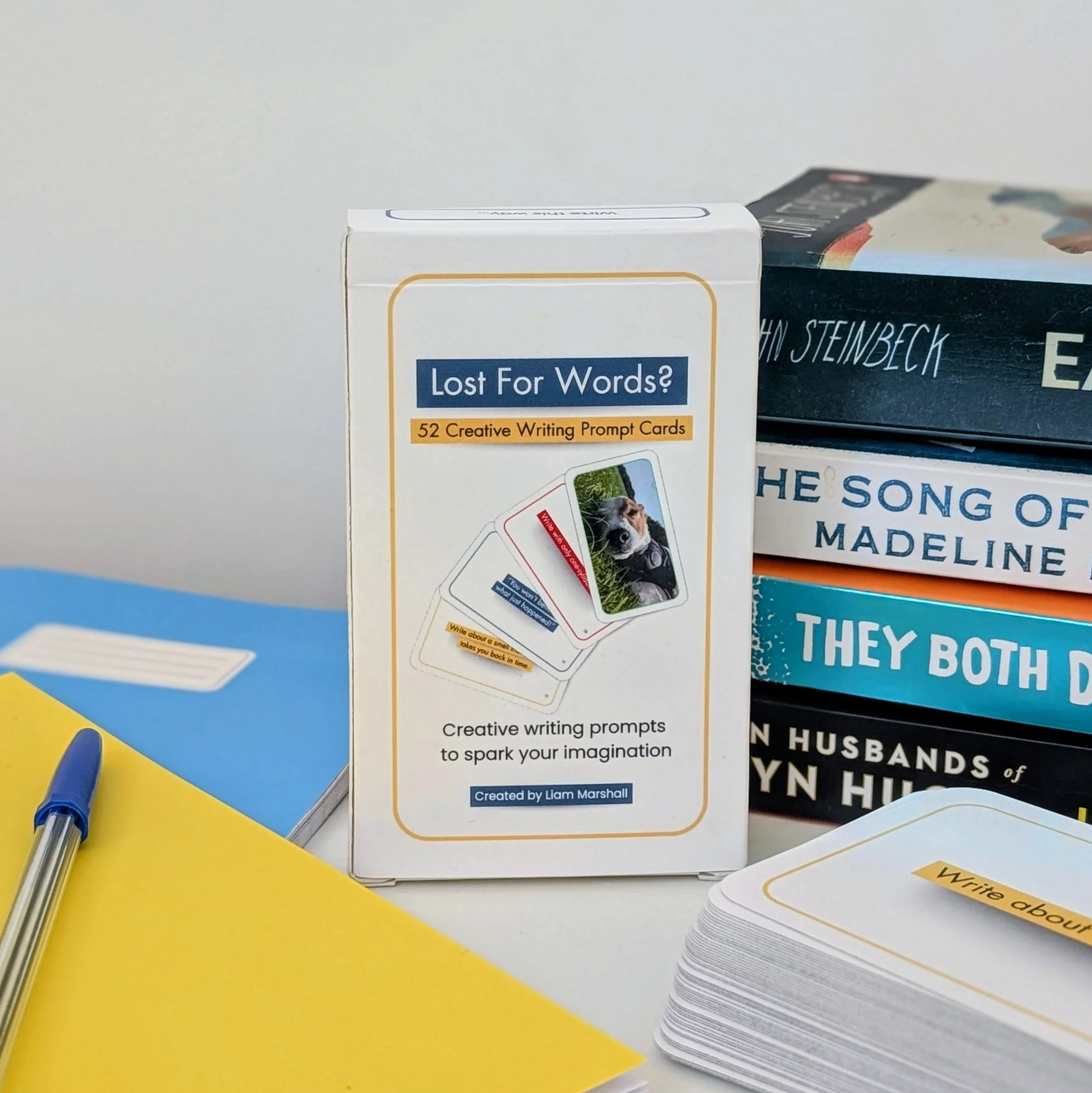 Lost For Words creative writing prompt cards box displayed beside notebooks, pen and stacked books