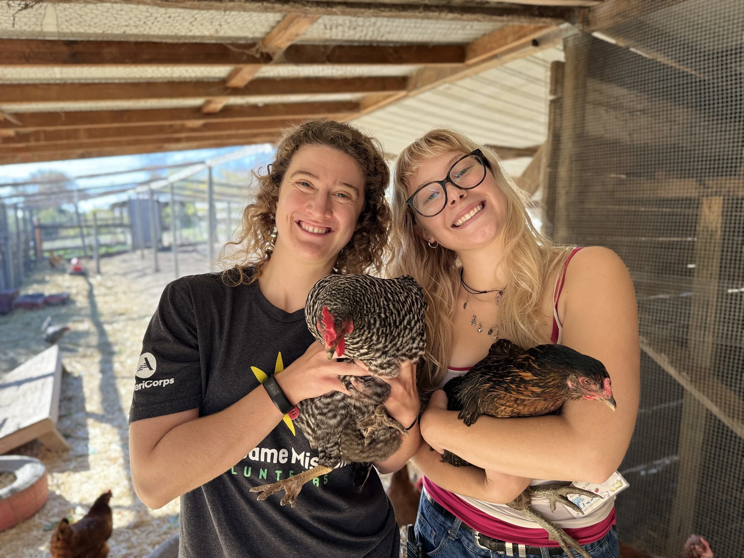 Catherine + member holding chickens.jpg