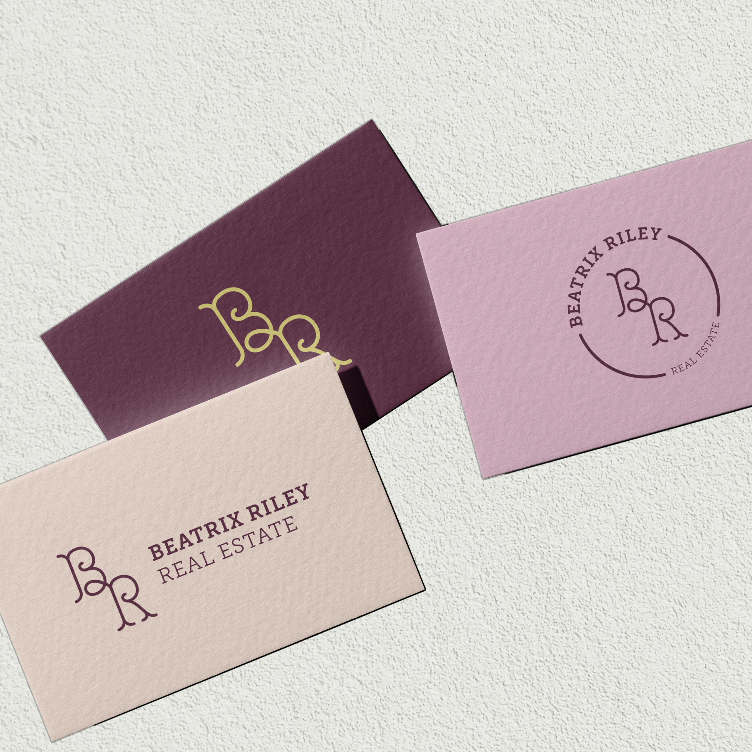 Business cards with multiple layouts of The Beatrix monogram logo. 