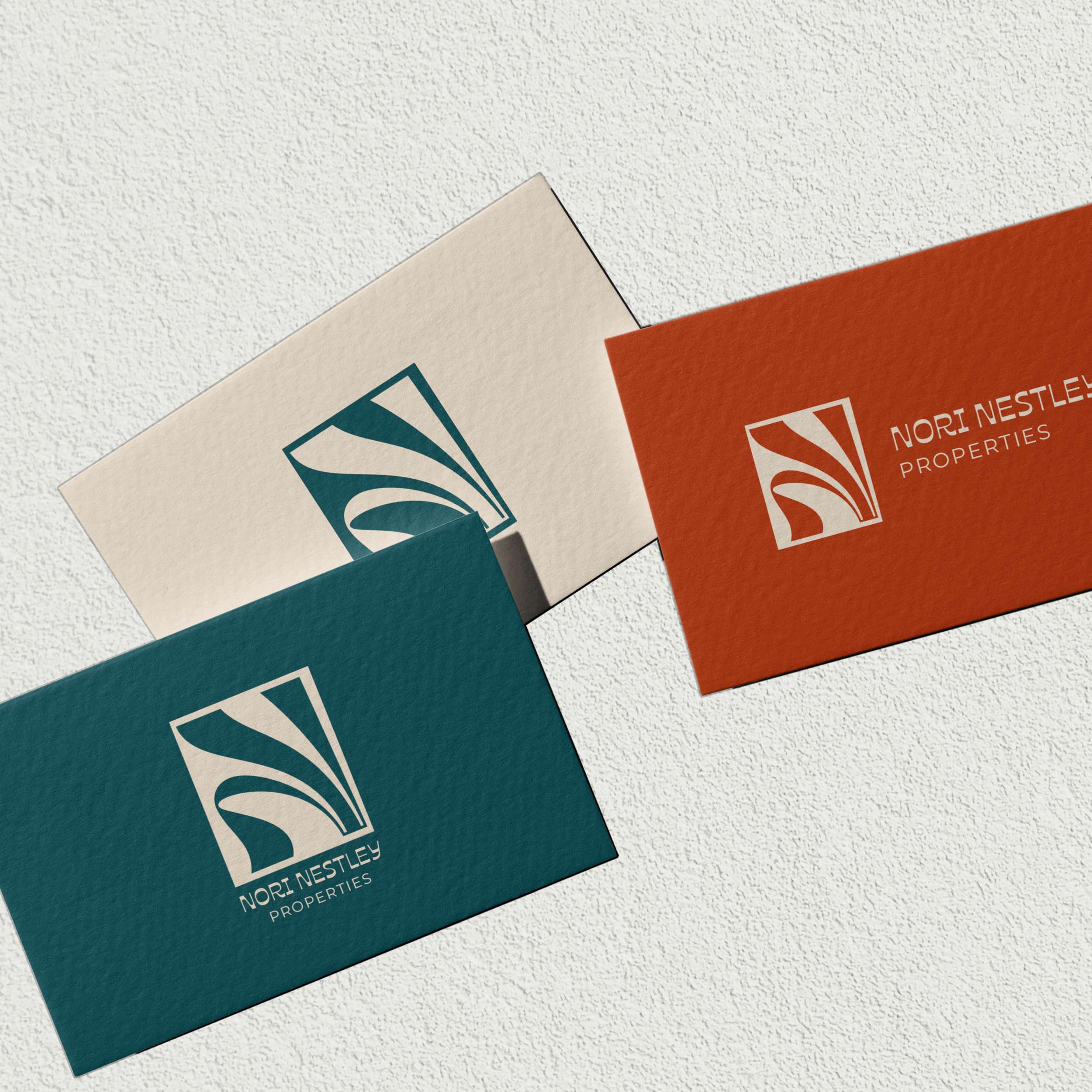 Business cards with multiple layouts of The Nori monogram logo.


