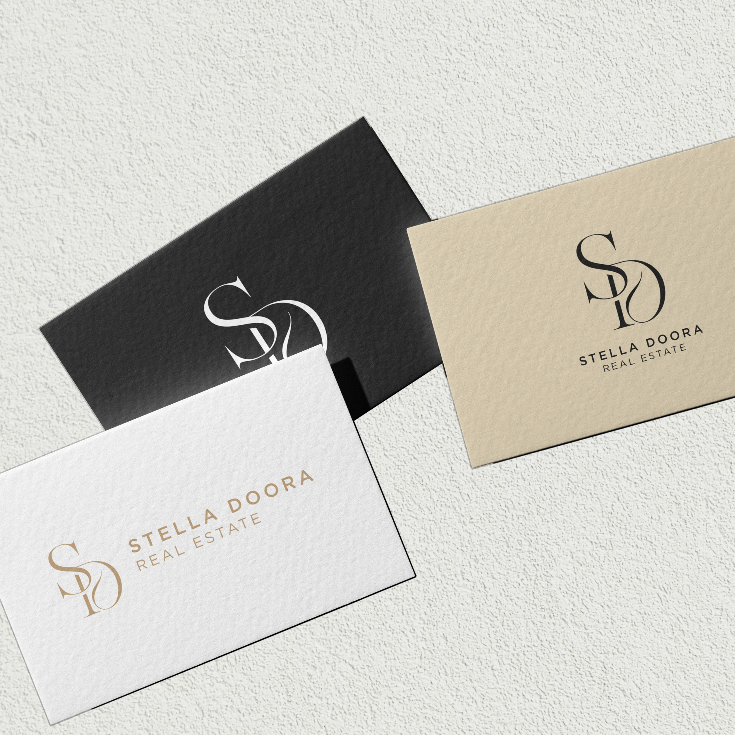 Business cards with multiple layouts of The Stella monogram logo.