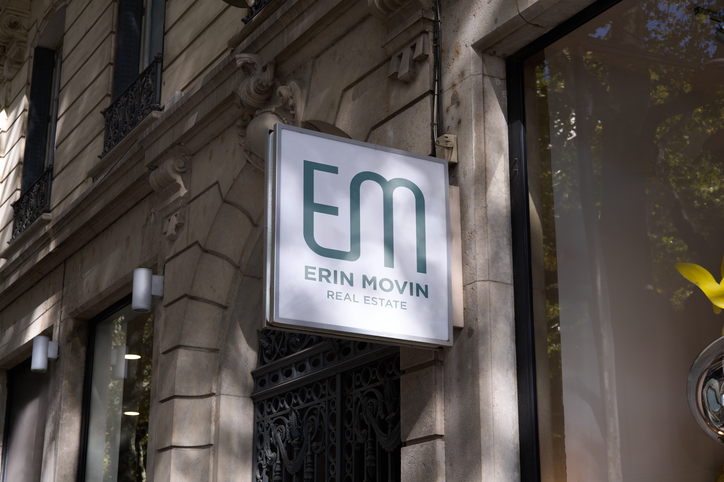 A business sign with The Erin monogram logo on the outside of a building.