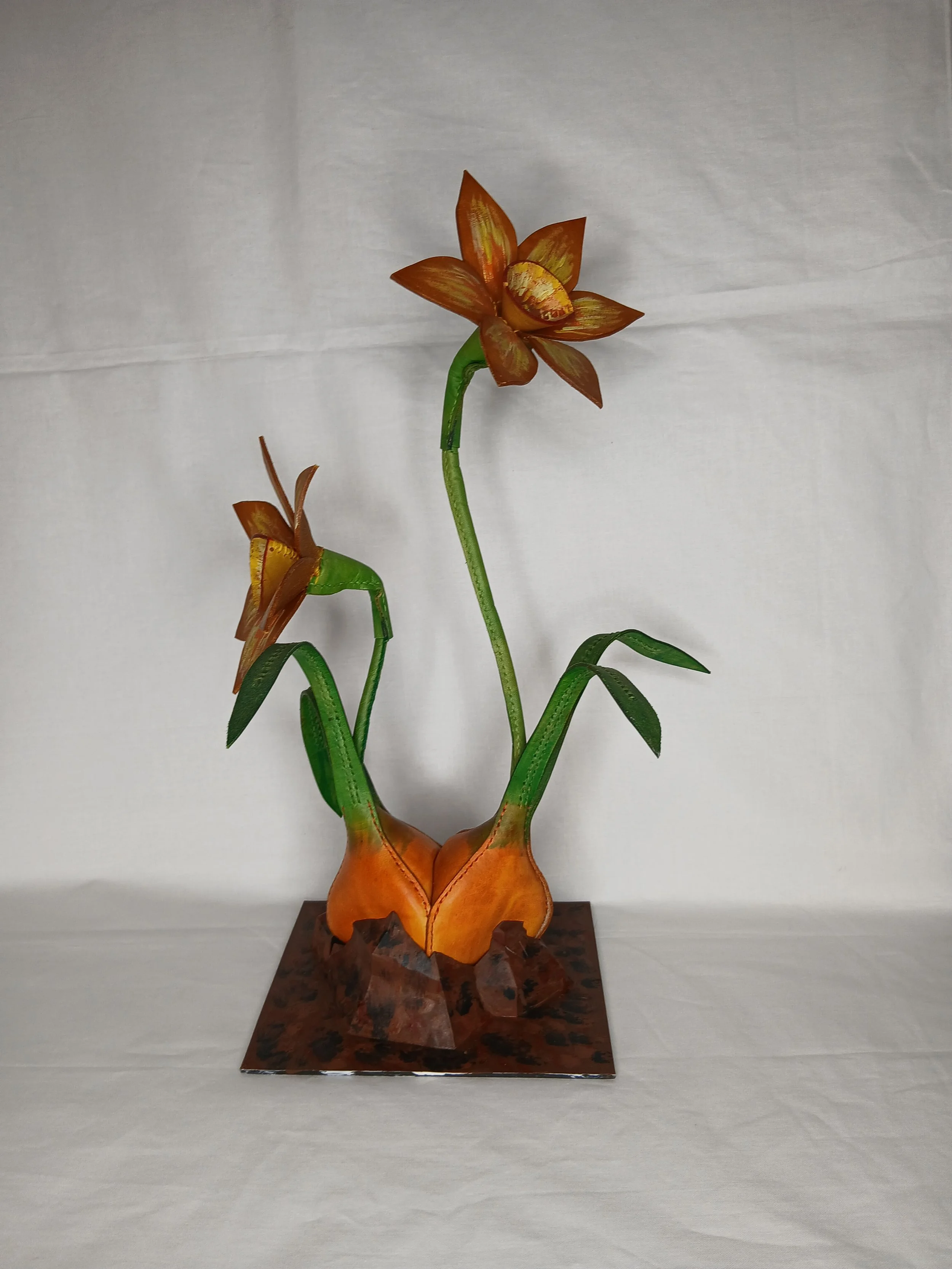 𝗛𝗲𝗿𝗮𝗹𝗱 𝗼𝗳 𝗦𝗽𝗿𝗶𝗻𝗴 — A stunning botanical study depicting a pair of vibrant daffodils rising gracefully from hand-formed bulbs, anchored on a beautifully textured base.
