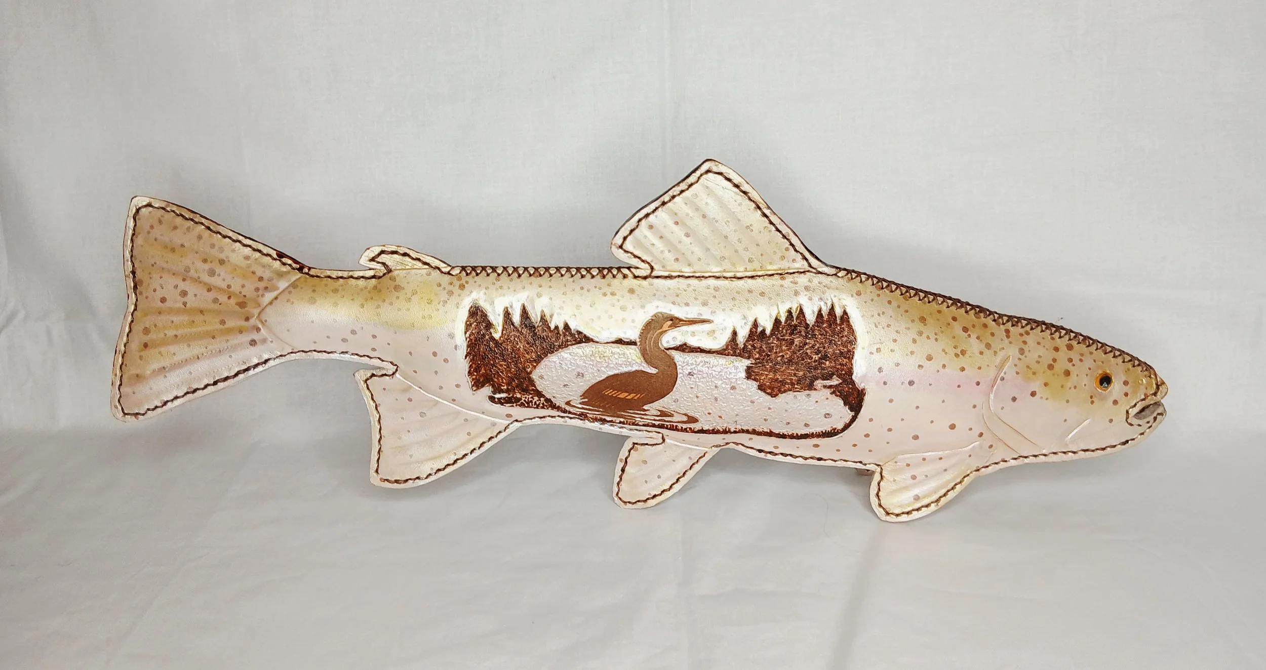 𝗦𝗵𝗮𝗱𝗼𝘄𝘀 𝗼𝗳 𝗙𝗮𝘁𝗲 — A detailed, hand-carved wildlife landscape scene featuring a Cormorant intricately embedded into the form of a Rainbow Trout.