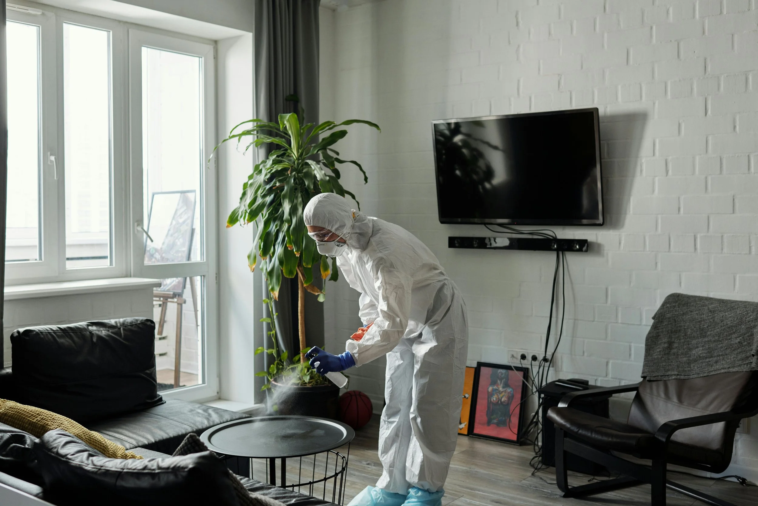 Man cleaning , TV in background