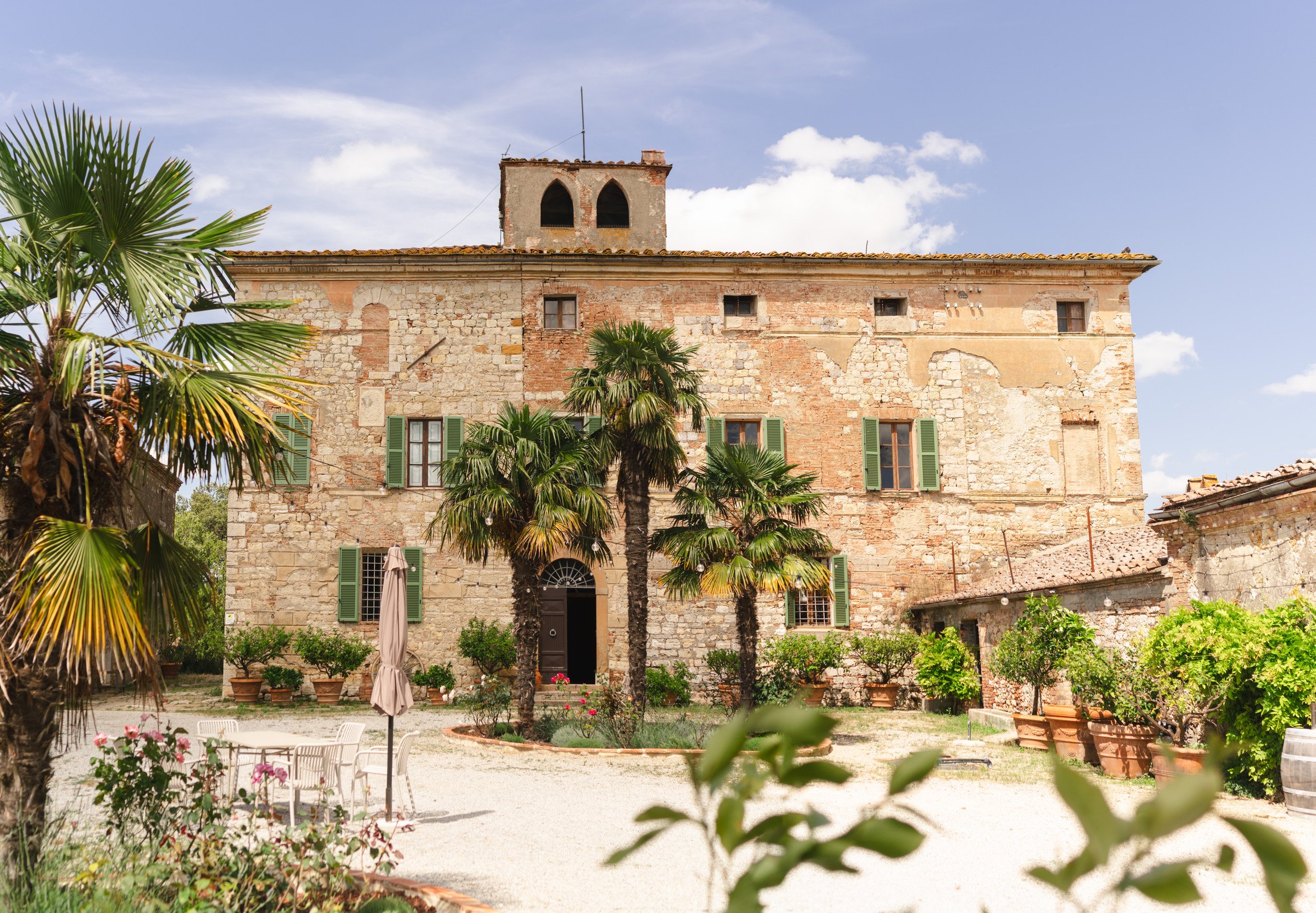 Row of Pilates reformer machines in a bright, spacious fitness studio with arched mirrors and soft lighting.