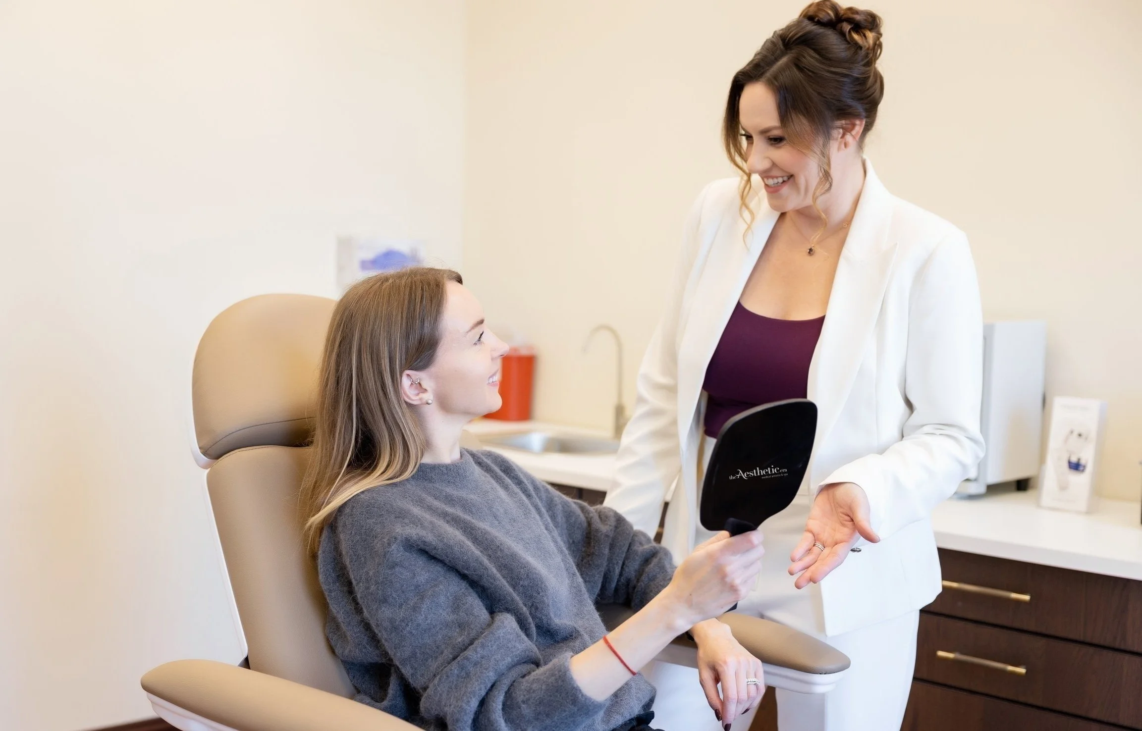 Clean, professional medical spa treatment room with neutral tones at The Aesthetic Era in Richmond