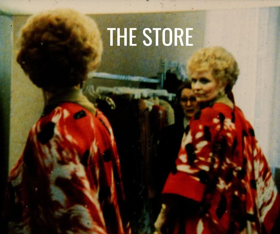Person in a red and white patterned robe standing in front of a mirror with "THE STORE" text overlay.