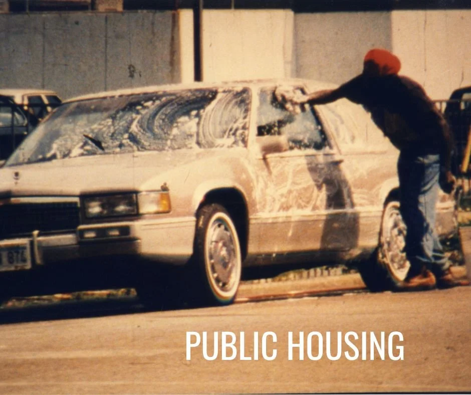 Person washing a car outdoors with the text 'Public Housing' at the bottom.