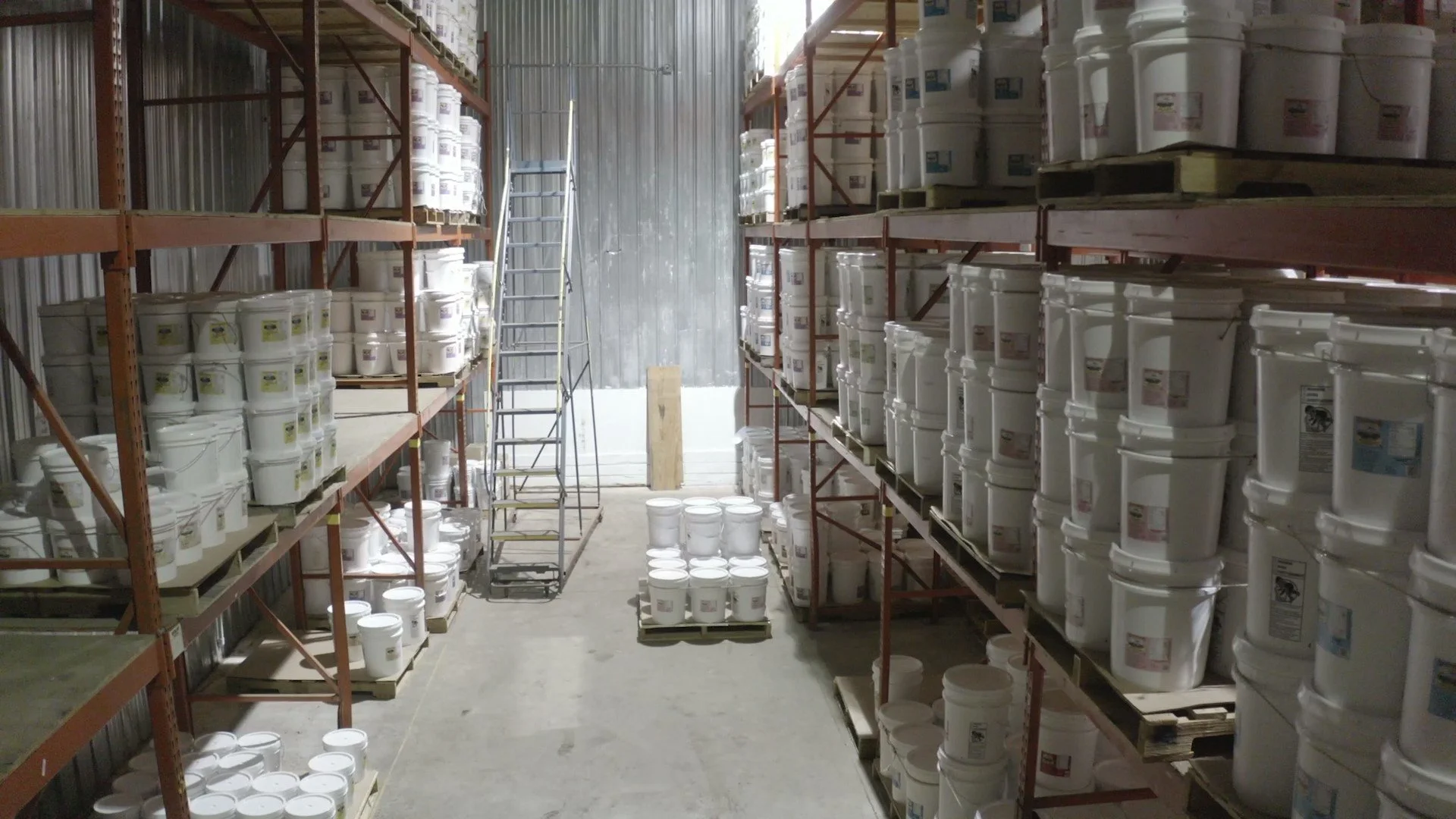 refrigerated warehouse of East Wind nut butters. Rack filled with pallets of bulk size 35lb. tubs of nut butters.