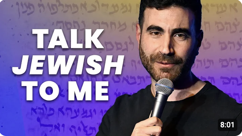 Man holding mic, with the caption, "Talk Jewish to Me."