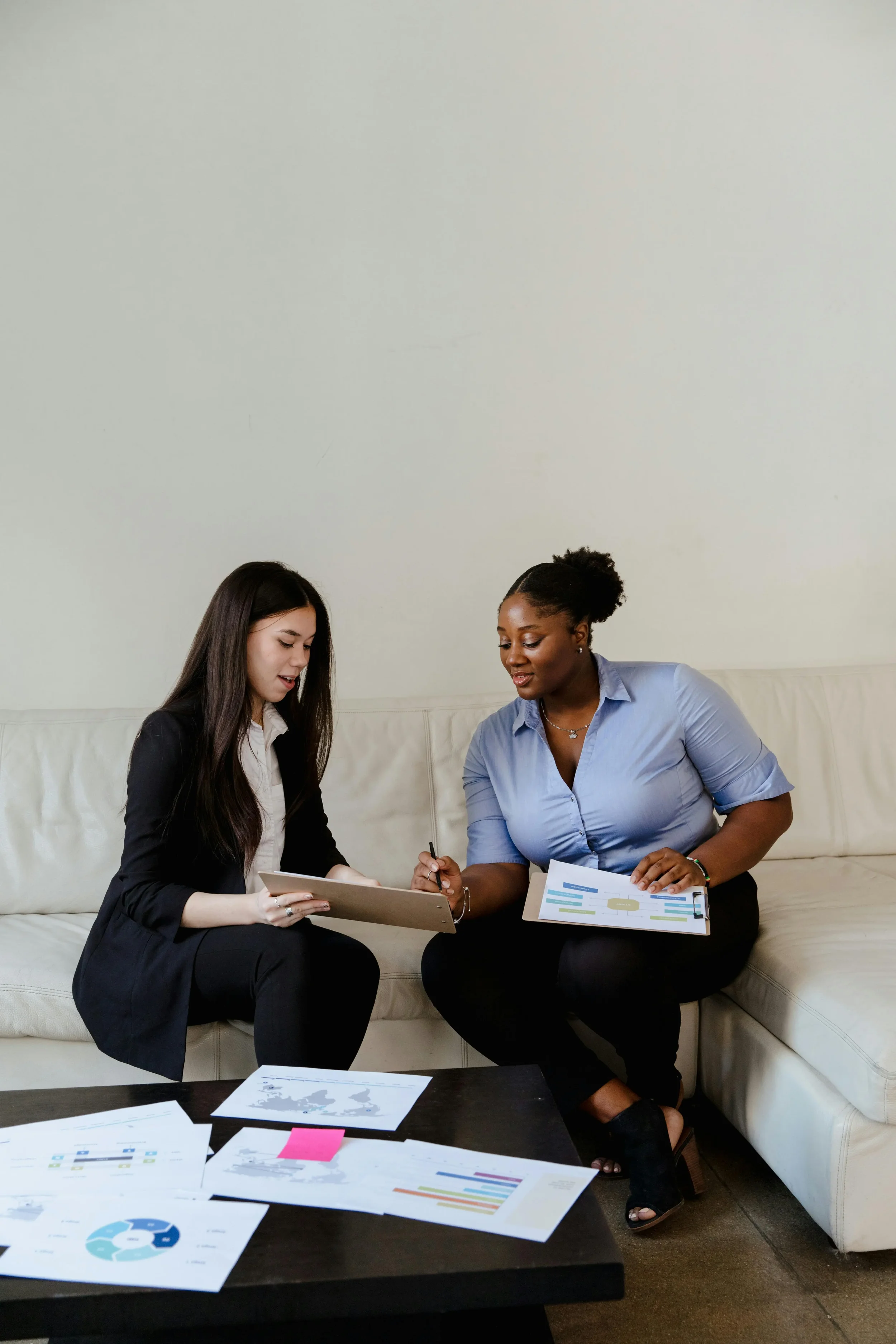 Woman presenting ideas on a board to a colleague, reflecting leadership roles and performance expectations