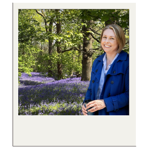 Jane Feilden posing in front of a bluebell wood in Lickey Hills.