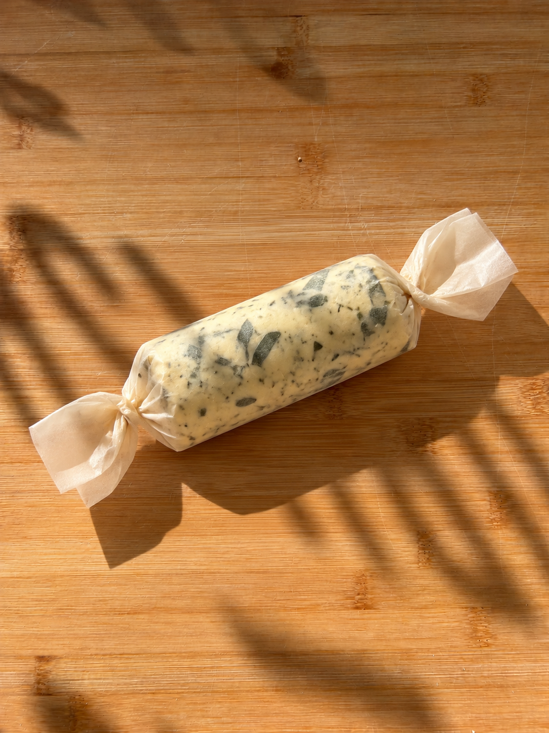 Sunlit Herb Butter on Parchment.png