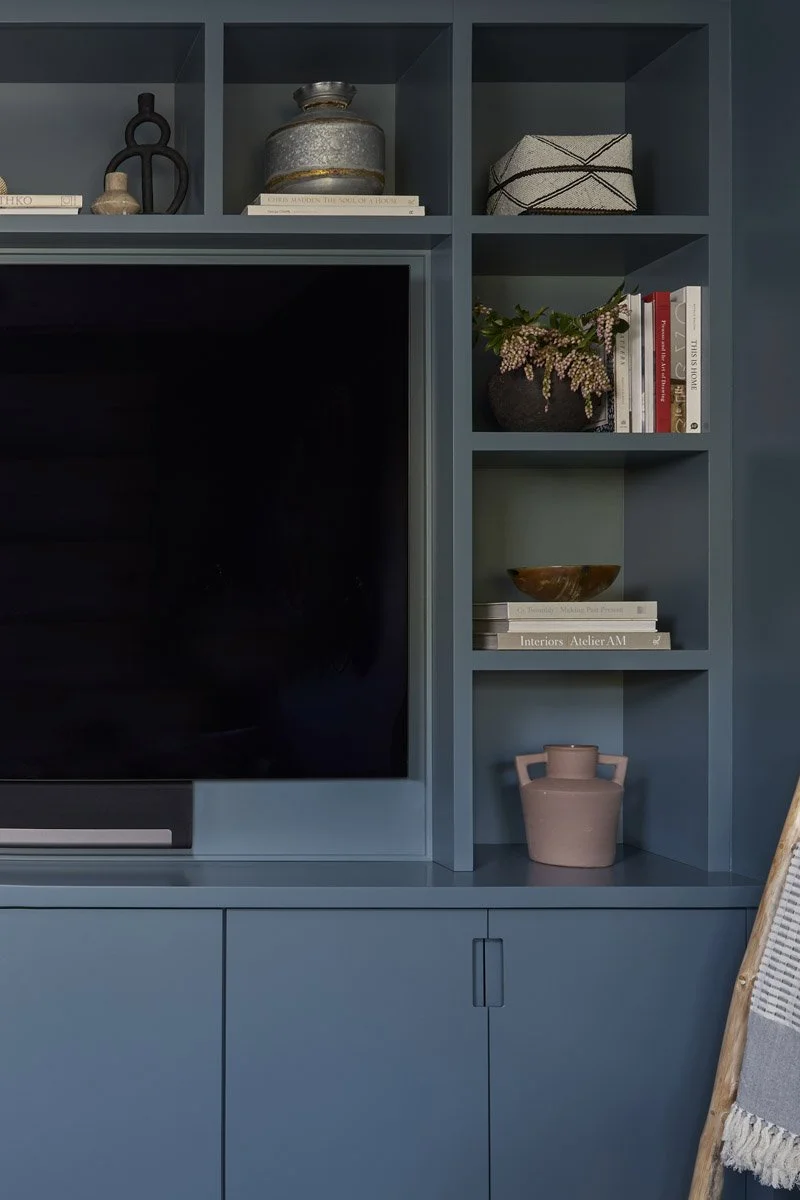 blue painted built-in shelving and media cabinet