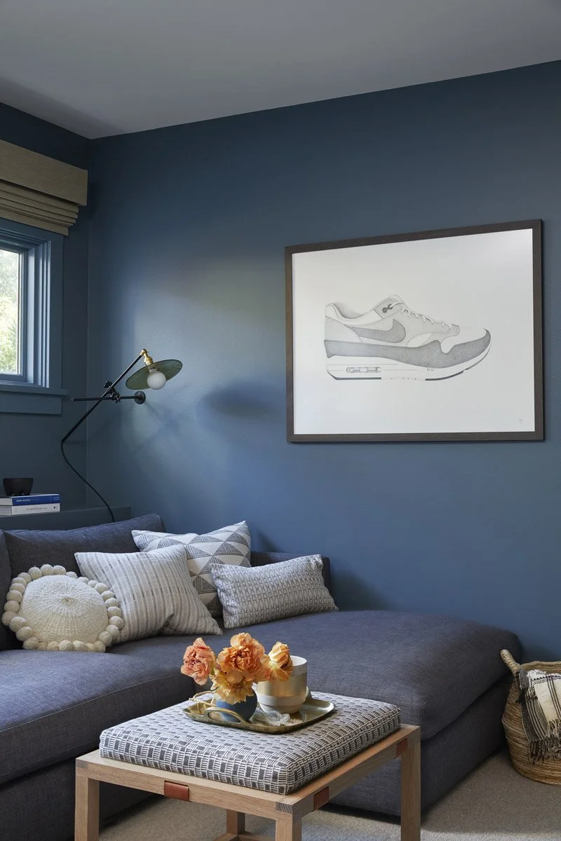 cosy blue family room corner with sectional sofa and upholstered ottoman